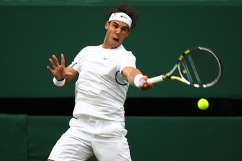 LONDON, ENGLAND - JUNE 20:  Rafael Nadal of Spain returns a shot during his first round match against Michael Russell of the United States on Day One of the Wimbledon Lawn Tennis Championships at the All England Lawn Tennis and Croquet Club on June 20, 20