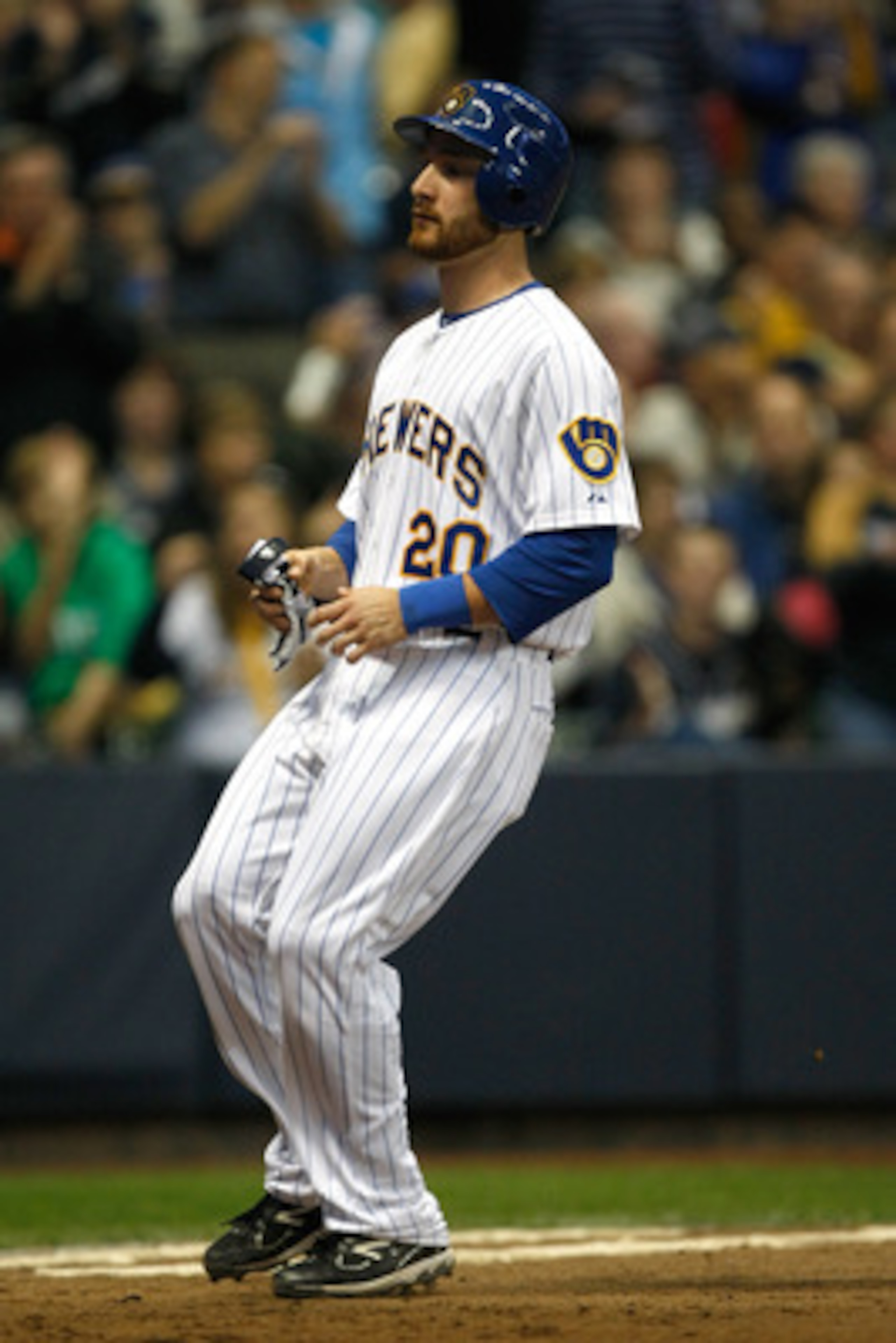 MILWAUKEE, WI - JUNE 10: Jonathan Lucroy #20 of the Milwaukee Brewers steps on home plate to score a run against the St. Louis Cardinals at Miller Park on June 10, 2011 in Milwaukee, Wisconsin. The Brewers defeated the Cardinals 8-0. (Photo by Scott Boehm