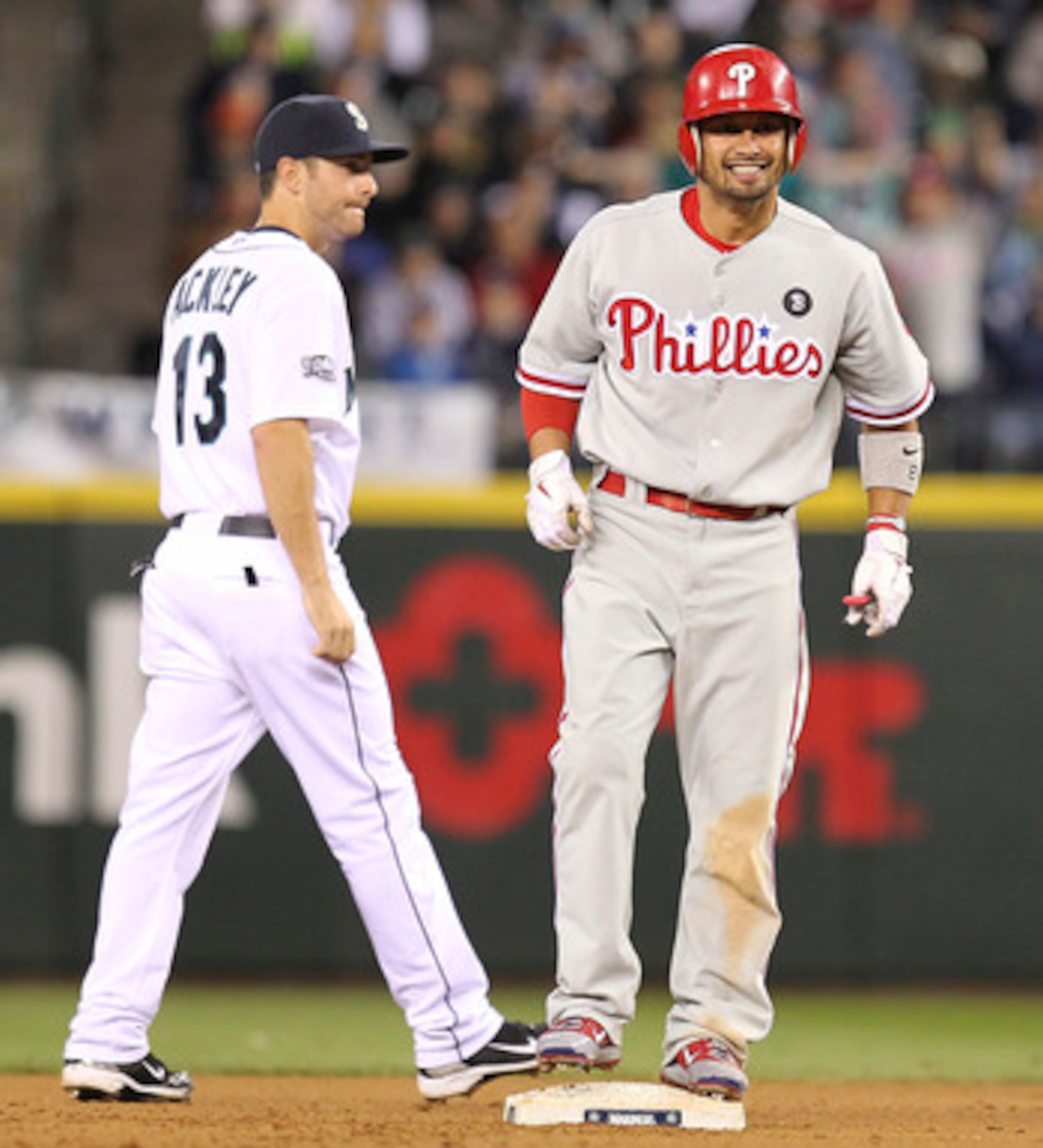 SEATTLE - JUNE 18:  Shane Victorino #8 of the Philadelphia Phillies stands at second base after hitting a 2 RBI double in the seventh inning as Dustin Ackley #13 of the Seattle Mariners looks on at Safeco Field on June 18, 2011 in Seattle, Washington. (Ph