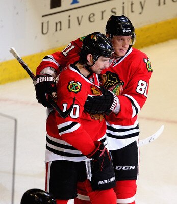 CHICAGO, IL - APRIL 19: Marian Hossa #81 of the Chicago Blackhawks congratulates teammate Patrick Sharp #10 after Sharp scored his second goal of the game against the Vancouver Canucks in Game Four of the Western Conference Quarterfinals during the 2011 N