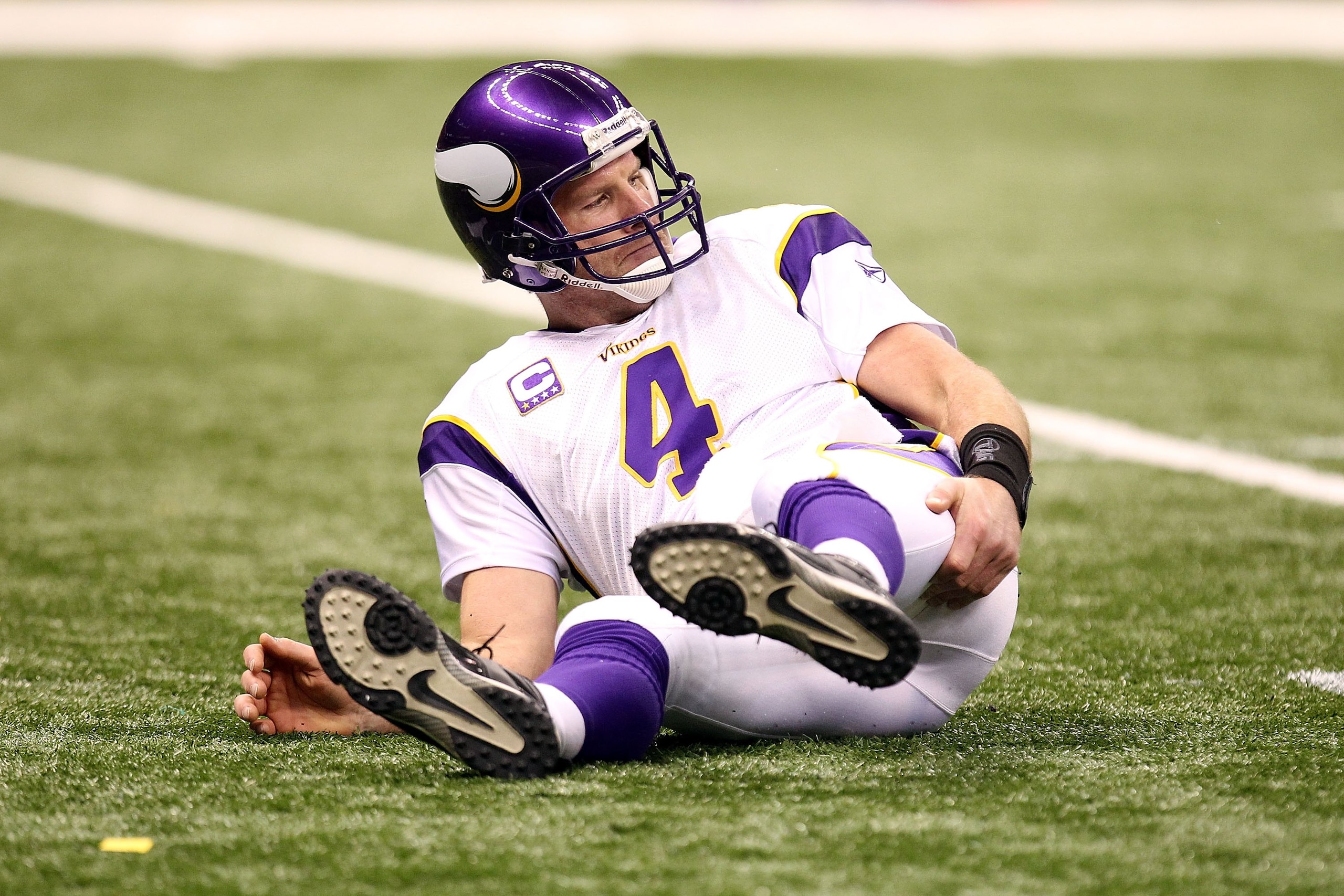 NEW ORLEANS - JANUARY 24:  Brett Favre #4 of the Minnesota Vikings grabs the back of his right leg as he sits on the turf after getting knocked down on a play against the New Orleans Saints during the NFC Championship Game at the Louisiana Superdome on Ja