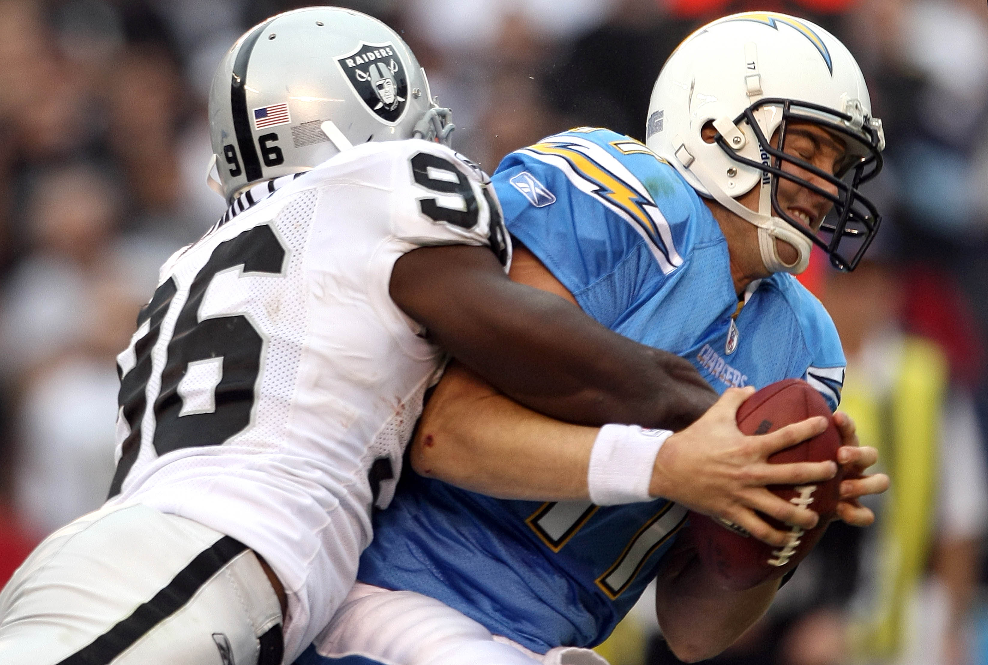 SAN DIEGO, CA - DECEMBER 5:  Quarterback Philip Rivers #17 of the San Diego Chargers is sacked by Kamerion Wimbley #96 of the Oakland Raiders during their NFL game at Qualcomm Stadium on December 5, 2010 in San Diego, California. (Photo by Donald Miralle/
