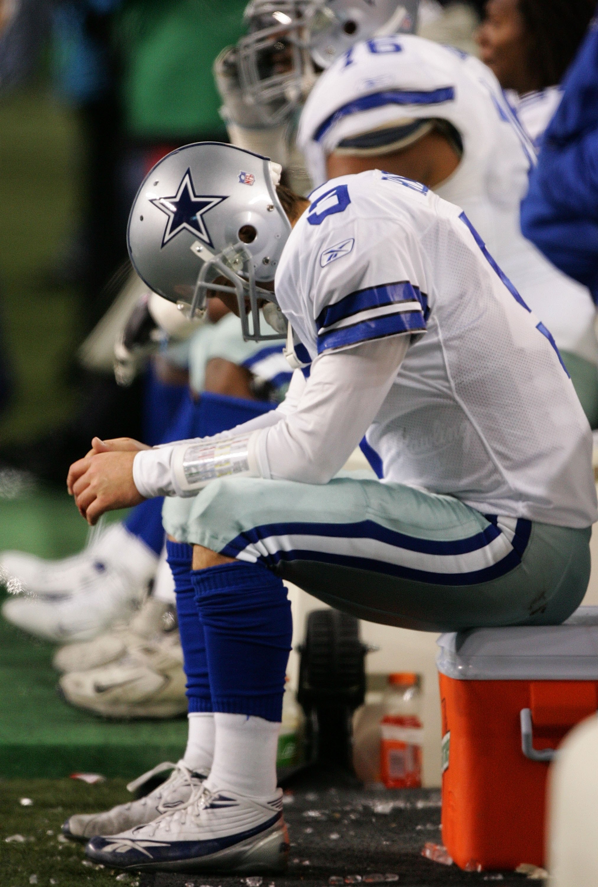 SEATTLE - JANUARY 06:  Quarterback Tony Romo #9 of the Dallas Cowboys sits dejected after fumbling the field goal snap in the fourth quarter of the NFC Wild Card Playoff Game against the Seattle Seahawks on January 6, 2007 at Qwest Field in Seattle, Washi