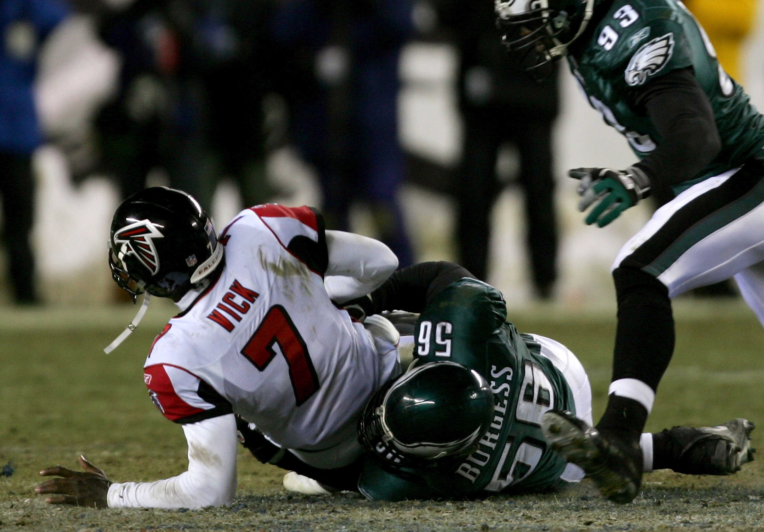 PHILADELPHIA - JANUARY 23:  Quarterback Michael Vick #7 of the Atlanta Falcons is sacked by Derrick Burgess #56 of Philadelphia Eagles during the NFC Championship game at Lincoln Financial Field on January 23, 2005 in Philadelphia, Pennsylvannia.  (Photo