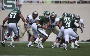 EAST LANSING, MI - SEPTEMBER 05: Quarterback Kirk Cousins #8 of the Michigan State Spartans hands the ball off to Running Back Caulton Ray #24 of the Michigan State Spartans during the game against the Montana State Bobcats on September 5, 2009 at Spartan