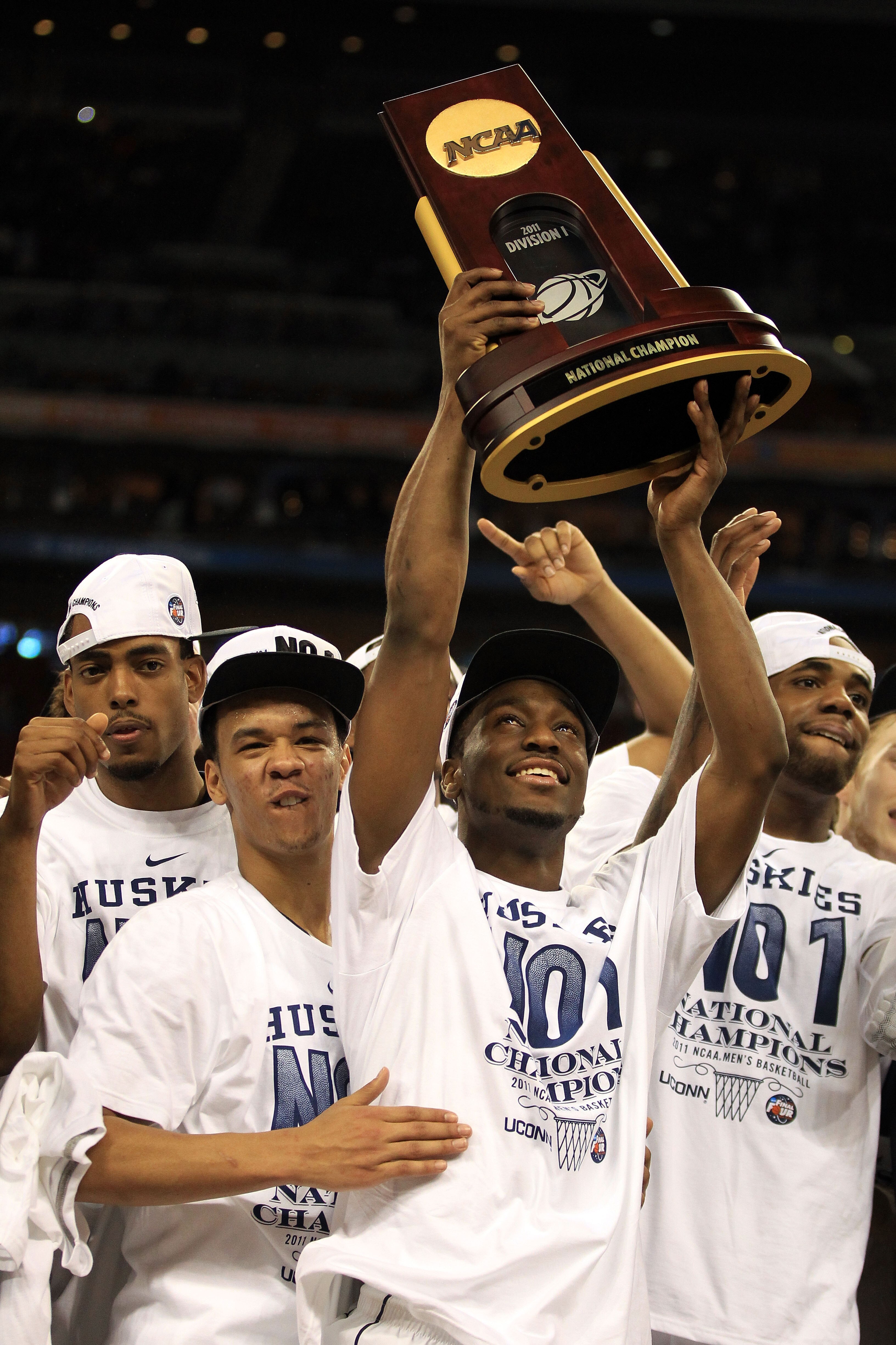 HOUSTON, TX - APRIL 04: Shabazz Napier #13 and Kemba Walker #15 of the Connecticut Huskies celebrate with the trophy after defeating the Butler Bulldogs to win the National Championship Game of the 2011 NCAA Division I Men's Basketball Tournament by a sc HOUSTON, TX - APRIL 04: Shabazz Napier #13 and Kemba Walker #15 of the Connecticut Huskies celebrate with the trophy after defeating the Butler Bulldogs to win the National Championship Game of the 2011 NCAA Division I Men's Basketball Tournament by a sc
