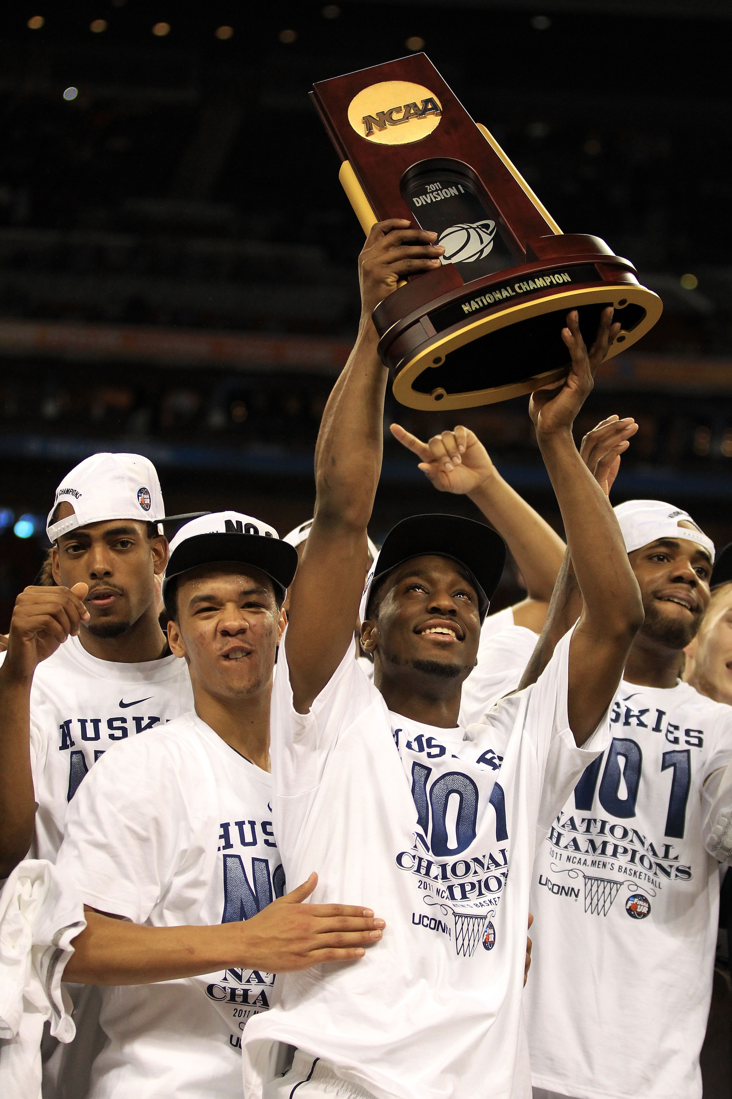 HOUSTON, TX - APRIL 04:  Shabazz Napier #13 and Kemba Walker #15 of the Connecticut Huskies celebrate with the trophy after defeating the Butler Bulldogs to win the National Championship Game of the 2011 NCAA Division I Men's Basketball Tournament by a sc