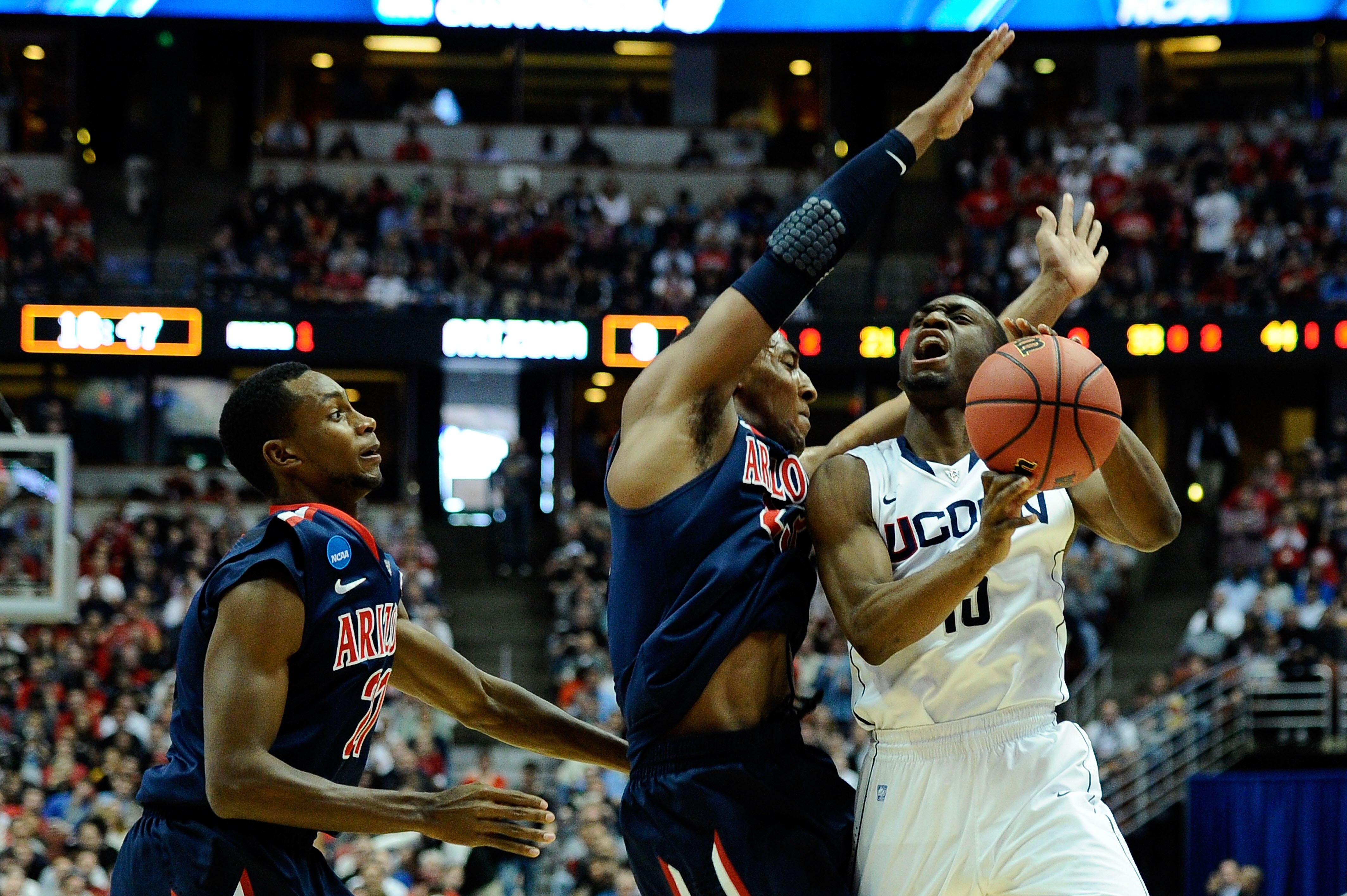 ANAHEIM, CA - MARCH 26: Kemba Walker #15 of the Connecticut Huskies handles the ball against Kyle Fogg #21 and Derrick Williams #23 of the Arizona Wildcats during the west regional final of the 2011 NCAA men's basketball tournament at the Honda Center on ANAHEIM, CA - MARCH 26: Kemba Walker #15 of the Connecticut Huskies handles the ball against Kyle Fogg #21 and Derrick Williams #23 of the Arizona Wildcats during the west regional final of the 2011 NCAA men's basketball tournament at the Honda Center on