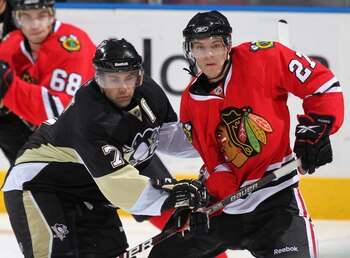 LONDON,ON - SEPTEMBER 14:  Jeremy Morin #27 of the Chicago Black Hawks battles with Brian Strait #7 of the Pittsburgh Penguins in a game during the NHL Rookie Tournament on September 14,2010 at the John Labatt Centre in London,Ontario. The Hawks defeated 
