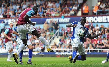 LONDON, ENGLAND - MAY 07:  Carlton Cole of West Ham United has his shot blocked by Christopher Samba of Blackburn Rovers during the Barclays Premier League match between West Ham United and Blackburn Rovers at the Boleyn Ground on May 7, 2011 in London, E