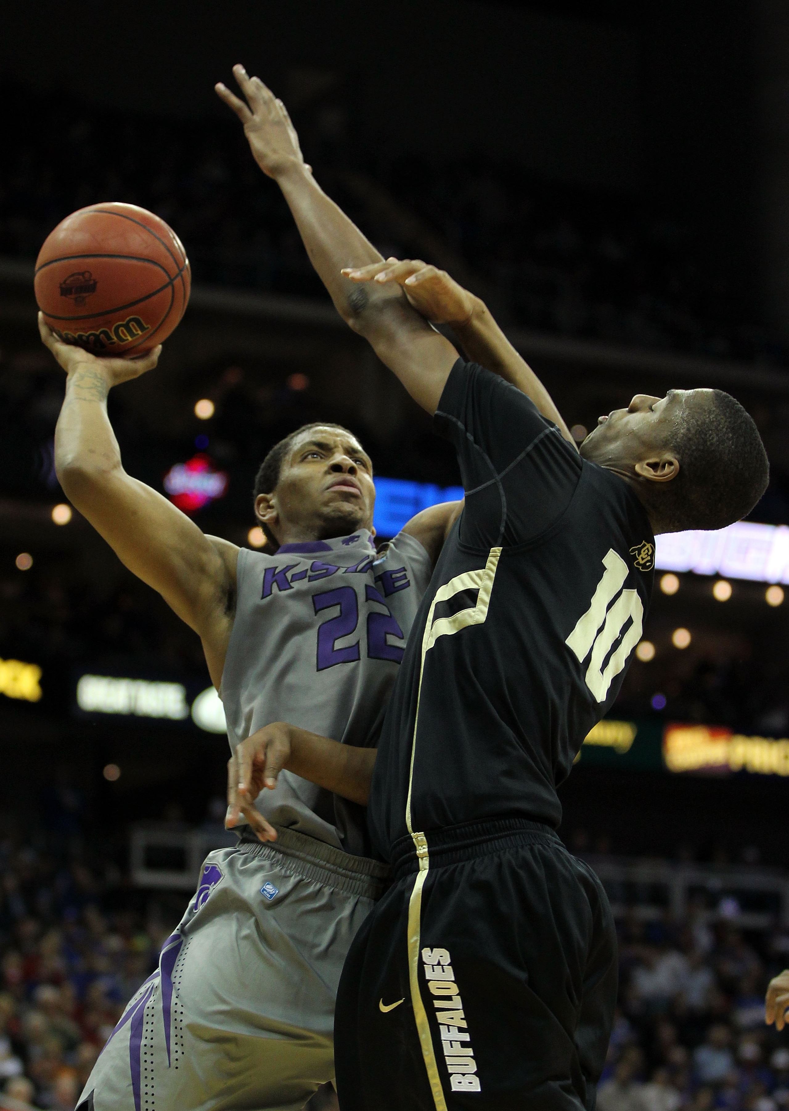 KANSAS CITY, MO - MARCH 10:  Rodney McGruder #22 of the Kansas State Wildcats goes up for a shot against Alec Burks #10 of the Colorado Buffaloes during their quarterfinal game in the 2011 Phillips 66 Big 12 Men's Basketball Tournament at Sprint Center on