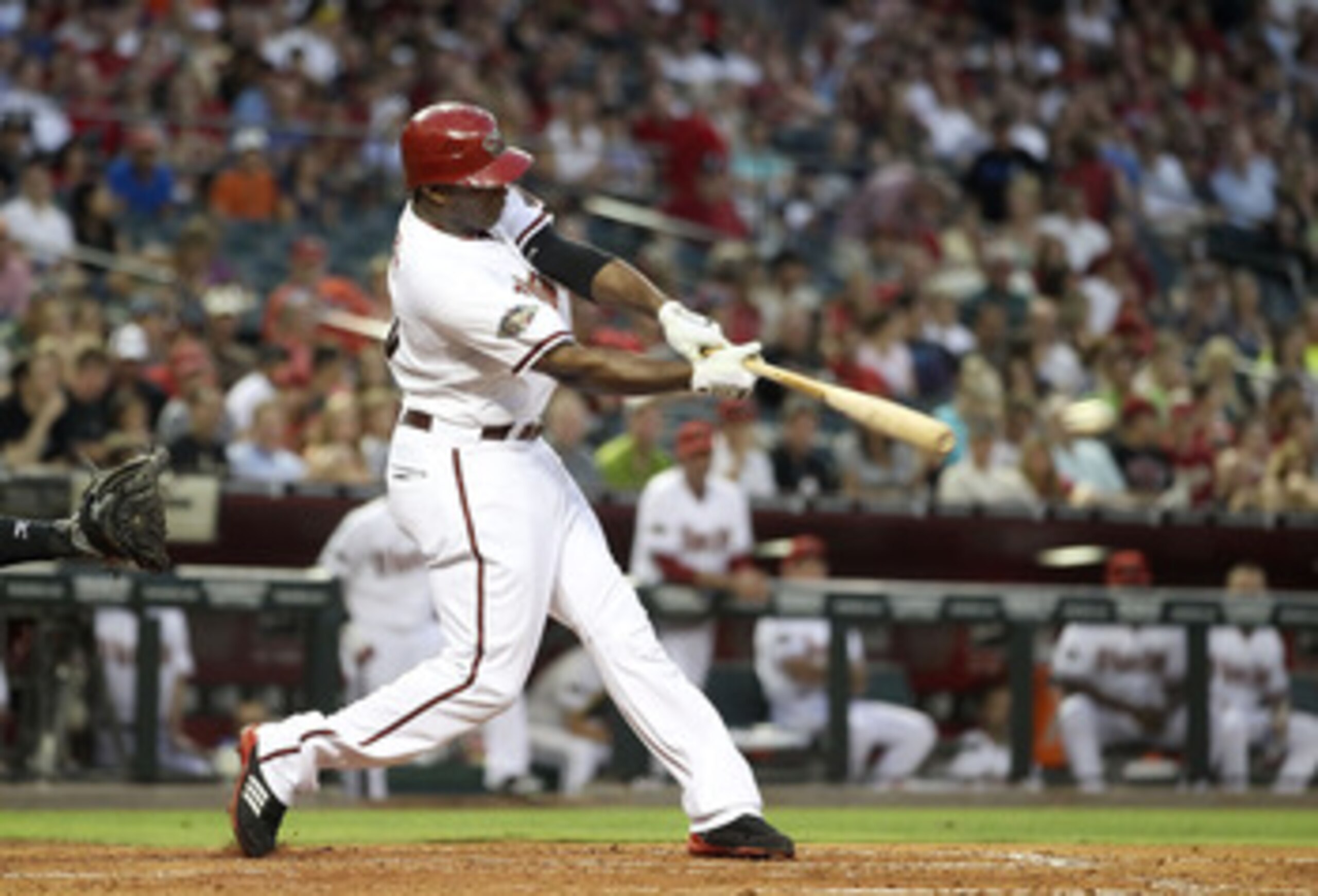PHOENIX, AZ - JUNE 14:  Justin Upton #10 of the Arizona Diamondbacks hits a single against the San Francisco Giants during the fourth inning of the Major League Baseball game at Chase Field on June 14, 2011 in Phoenix, Arizona.  (Photo by Christian Peters