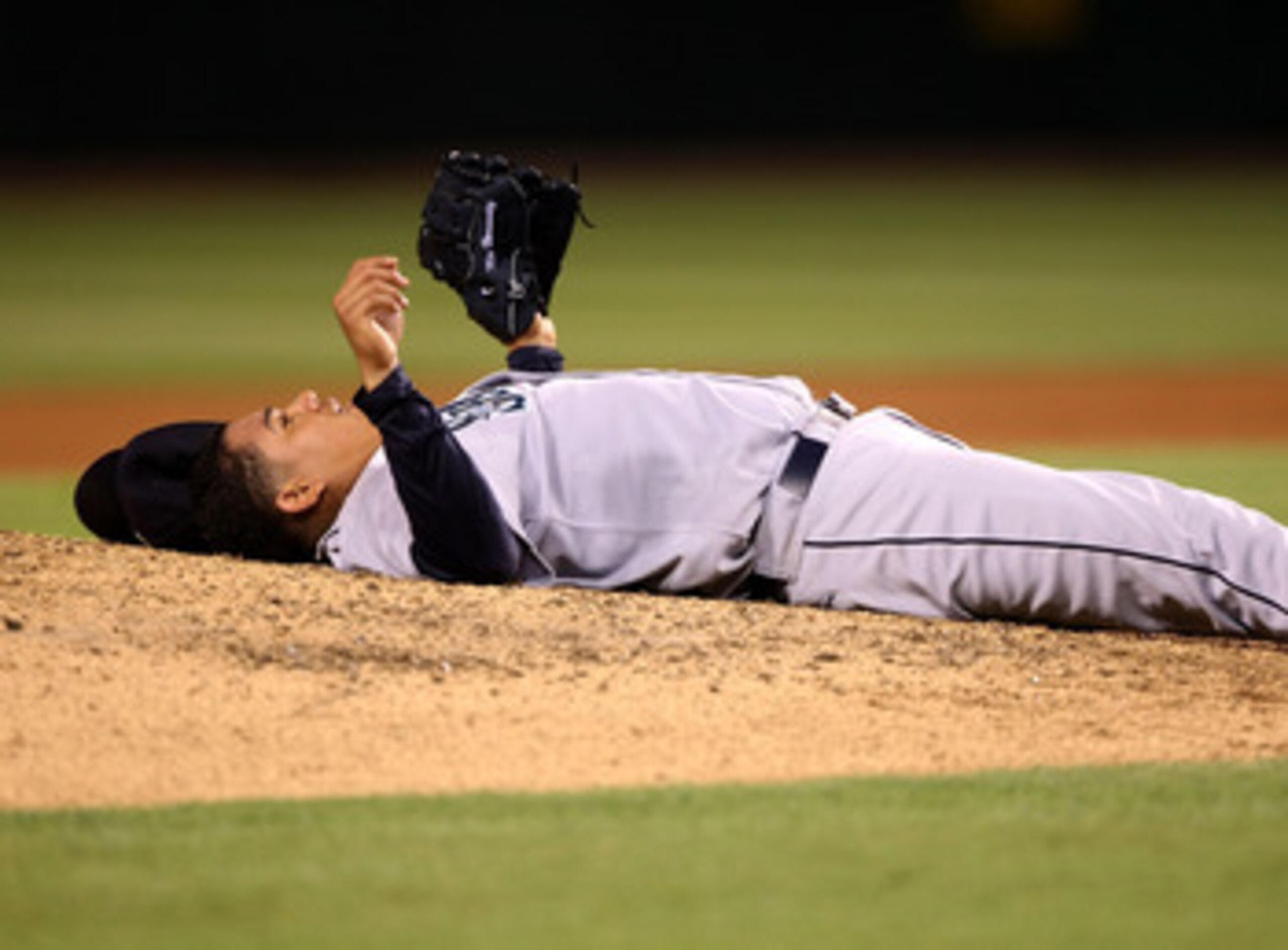 ANAHEIM, CA - AUGUST 13:  Pitcher Felix Hernandez #34 of the Seattle Mariners lies on his back after catching a hard line drive hit by Chone Figgins #9 of the Los Angeles Angels of Anaheim at Angel Stadium August 13, 2008 in Anaheim, California.  (Photo b