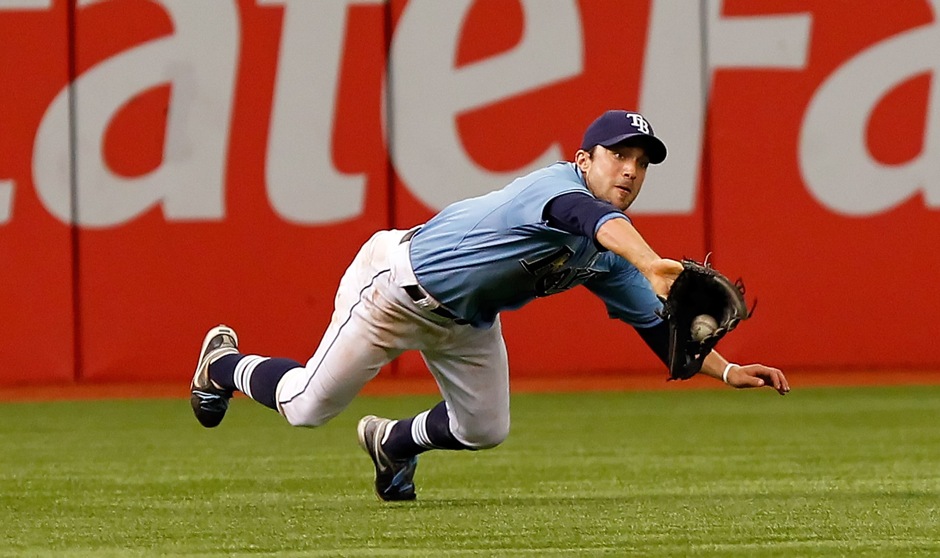 ST. PETERSBURG, FL - JUNE 19:  Outfielder Sam Fuld #5 of the Tampa Bay Rays makes a diving catch against the Florida Marlins during the game at Tropicana Field on June 19, 2011 in St. Petersburg, Florida.  (Photo by J. Meric/Getty Images)
