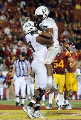 LOS ANGELES, CA - OCTOBER 30: LaMichael James #21 of the Oregon Ducks celebrates his touchdown with Darrion Weems #74 on way to a 53-32 victory over the USC Trojans during the fourth quarter at Los Angeles Memorial Coliseum on October 30, 2010 in Los Ang LOS ANGELES, CA - OCTOBER 30: LaMichael James #21 of the Oregon Ducks celebrates his touchdown with Darrion Weems #74 on way to a 53-32 victory over the USC Trojans during the fourth quarter at Los Angeles Memorial Coliseum on October 30, 2010 in Los Ang