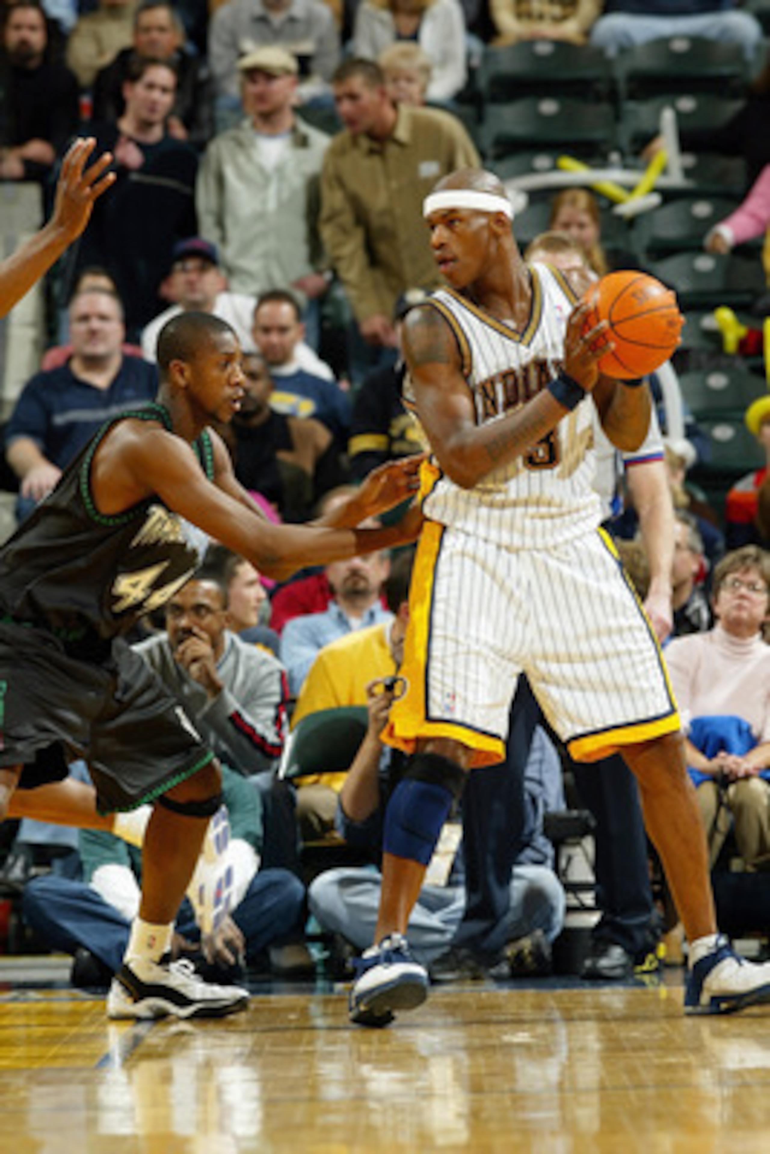 INDIANAPOLIS - NOVEMBER 25: Al Harrington #3 of the Indiana Pacers looks to make a play against Ndudi Ebi #44of the Minnesota Timberwolves during the game on November 25, 2003 at Conseco Fieldhouse in Indianapolis, Indiana. The Pacers won 98-75. NOTE T INDIANAPOLIS - NOVEMBER 25: Al Harrington #3 of the Indiana Pacers looks to make a play against Ndudi Ebi #44of the Minnesota Timberwolves during the game on November 25, 2003 at Conseco Fieldhouse in Indianapolis, Indiana. The Pacers won 98-75. NOTE T