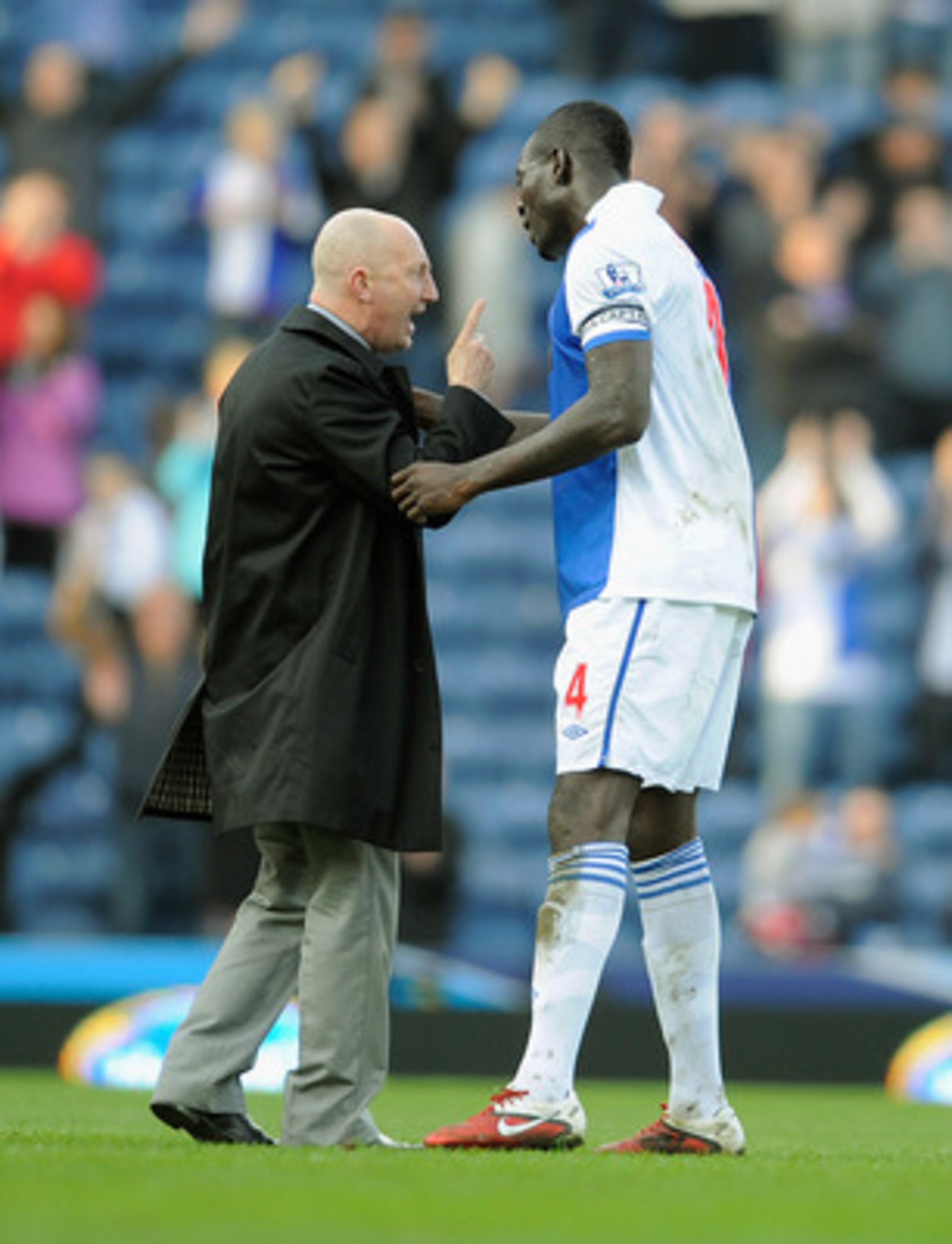 BLACKBURN, ENGLAND - MARCH 19: Blackpool manager Ian Holloway speaks with Christopher Samba of Blackburn after the Barclays Premier League match between Blackburn Rovers and Blackpool at Ewood Park on March 19, 2011 in Blackburn, England.  (Photo by Micha