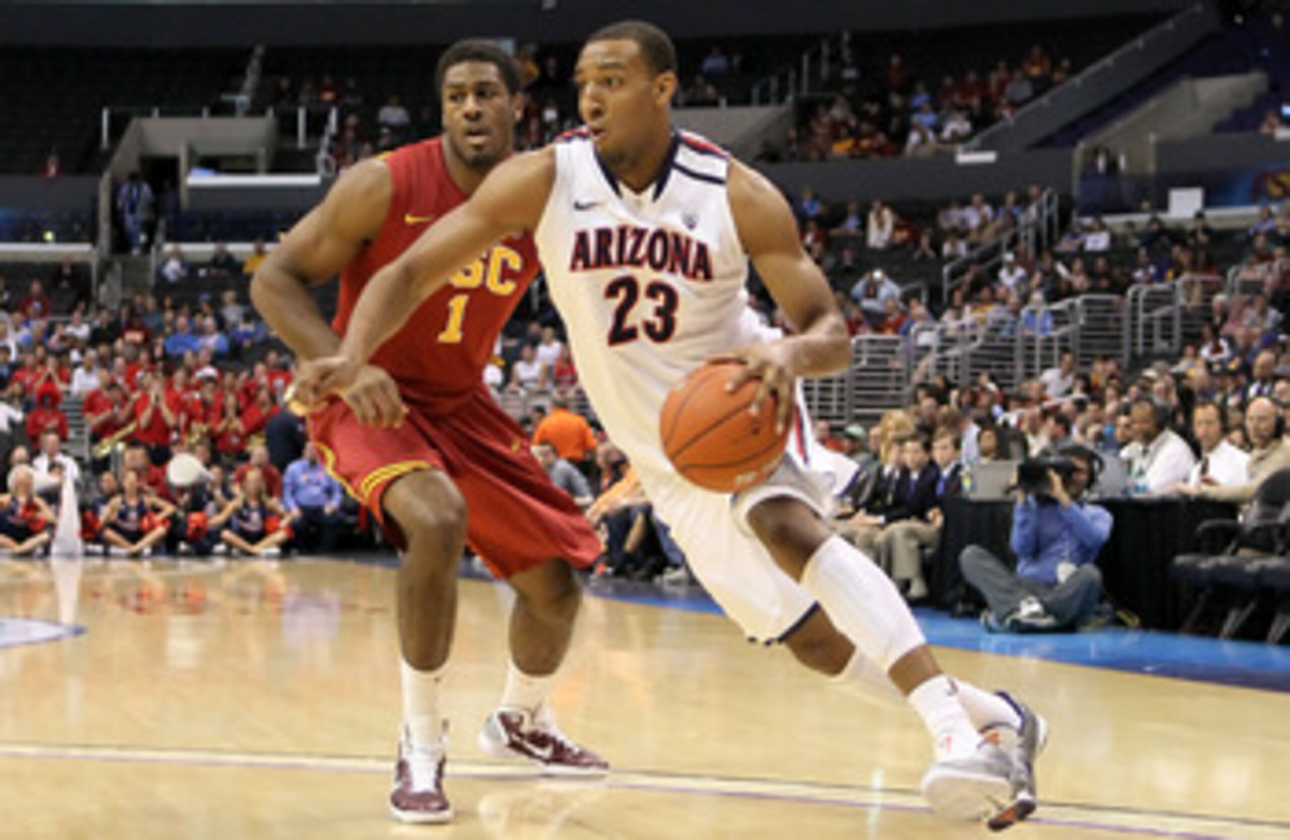 LOS ANGELES, CA - MARCH 11:  Derrick Williams #23 of the Arizona Wildcats drives on Alex Stepheson #1 of the USC Trojans in the first half in the semifinals of the 2011 Pacific Life Pac-10 Men's Basketball Tournament at Staples Center on March 11, 2011 in