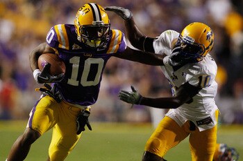 BATON ROUGE, LA - OCTOBER 16:  Russell Shepard #10 of the Louisiana State University Tigers is tackled by London Durham #10 of the McNeese State Cowboys at Tiger Stadium on October 16, 2010 in Baton Rouge, Louisiana.  The Tigers defeated the Cowboys 32-10