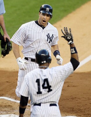 NEW YORK, NY - JUNE 15:  Mark Teixeira #25 of the New York Yankees celebrates his first inning two run home run against the Texas Rangers with teammate Curtis Granderson #14 on June 15, 2011 at Yankee Stadium in the Bronx borough of New York City.  (Photo