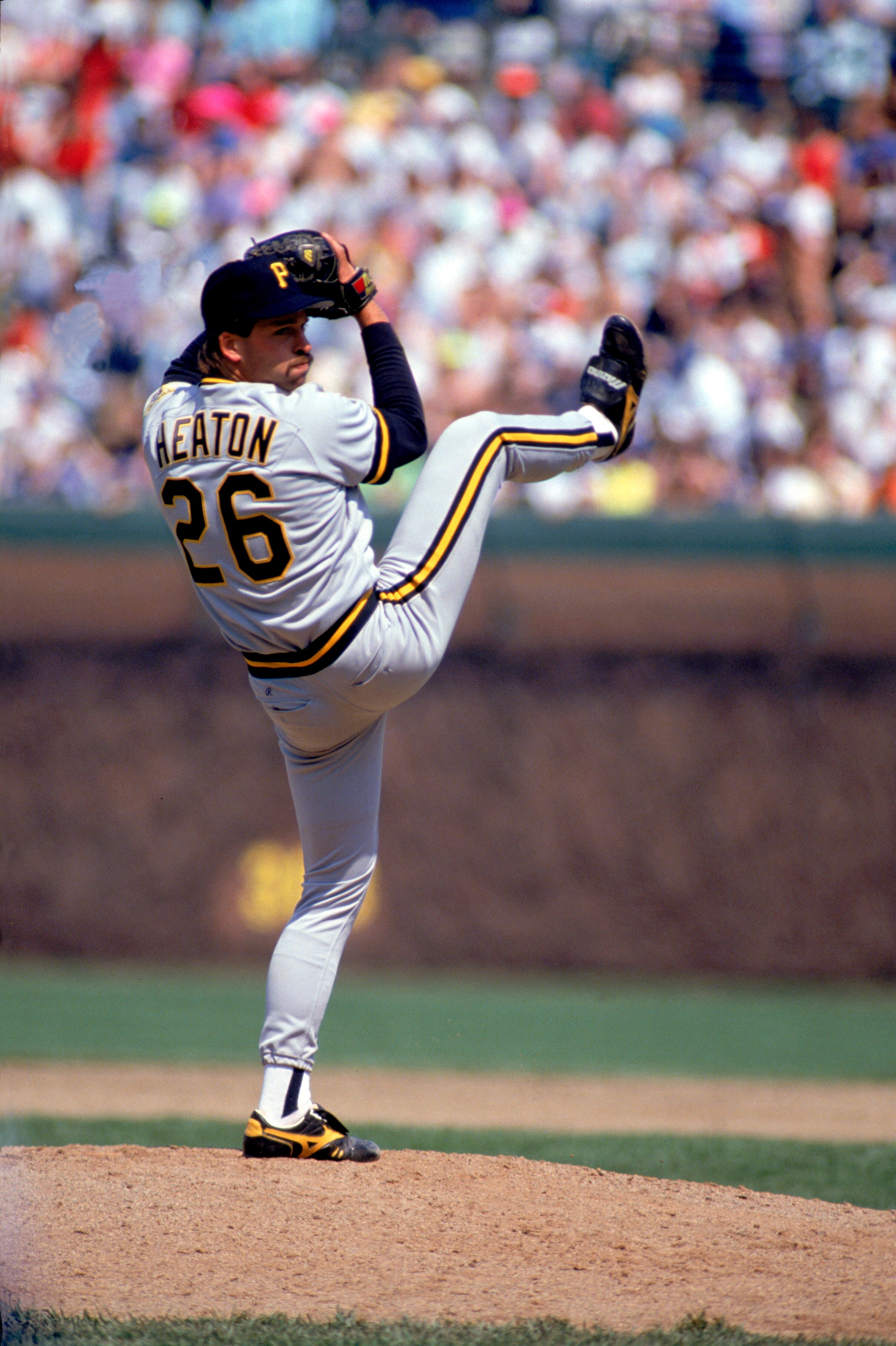 CHICAGO - 1990:  Neal Heaton #26 of the Pittsburgh Pirates winds up for a pitch during a 1990 MLB season game against the Chicago Cubs at Wrigley Field in Chicago, Illinois.  (Photo by Jonathan Daniel/Getty Images)