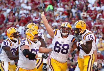 TUSCALOOSA, AL - NOVEMBER 07:  Deangelo Peterson #19 of the Louisiana State University Tigers celebrates his touchdown against the Alabama Crimson Tide with Josh Dworaczyk #68, Lyle Hitt #65 and Terrance Toliver #80 at Bryant-Denny Stadium on November 7,