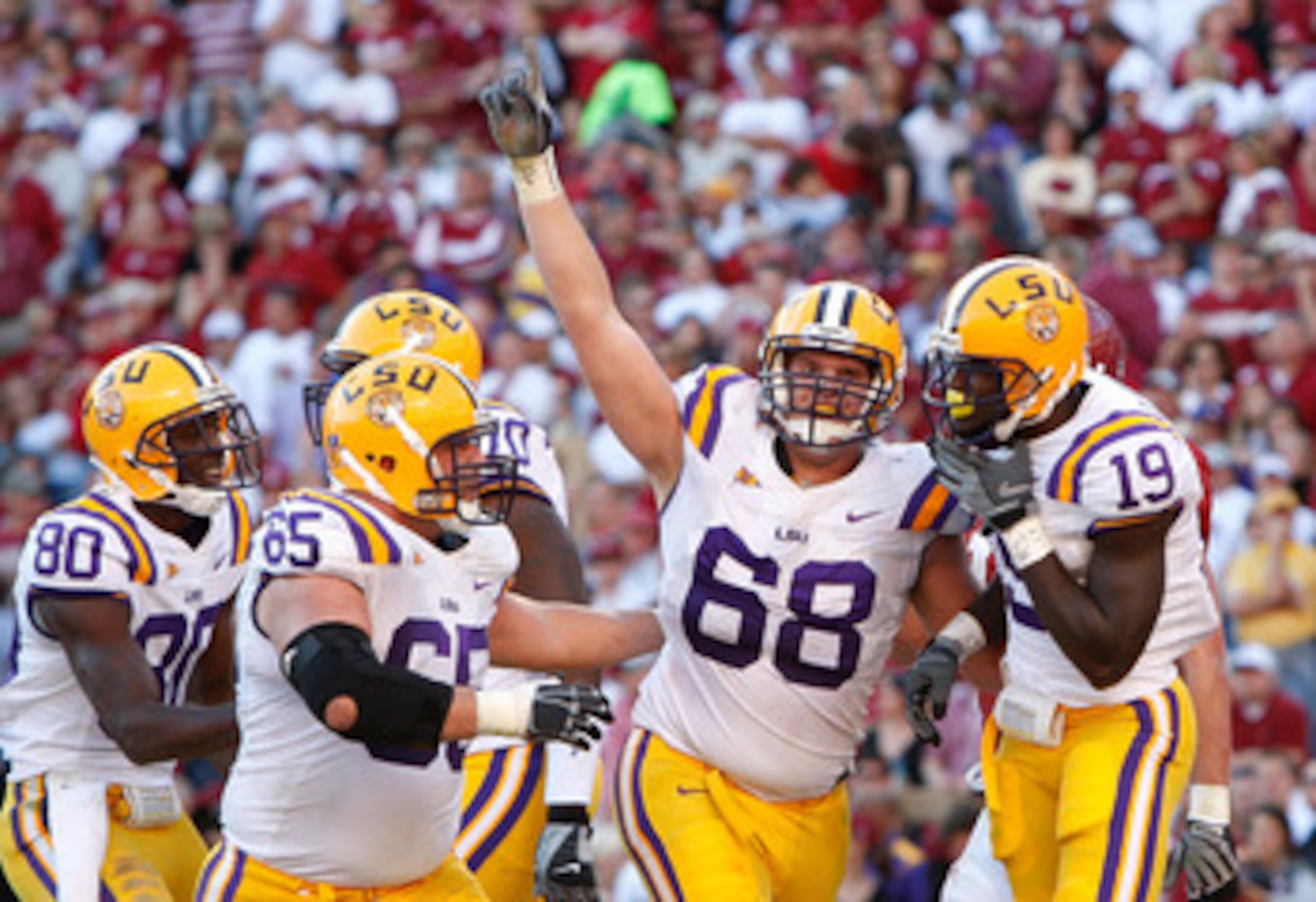 TUSCALOOSA, AL - NOVEMBER 07:  Deangelo Peterson #19 of the Louisiana State University Tigers celebrates his touchdown against the Alabama Crimson Tide with Josh Dworaczyk #68, Lyle Hitt #65 and Terrance Toliver #80 at Bryant-Denny Stadium on November 7,