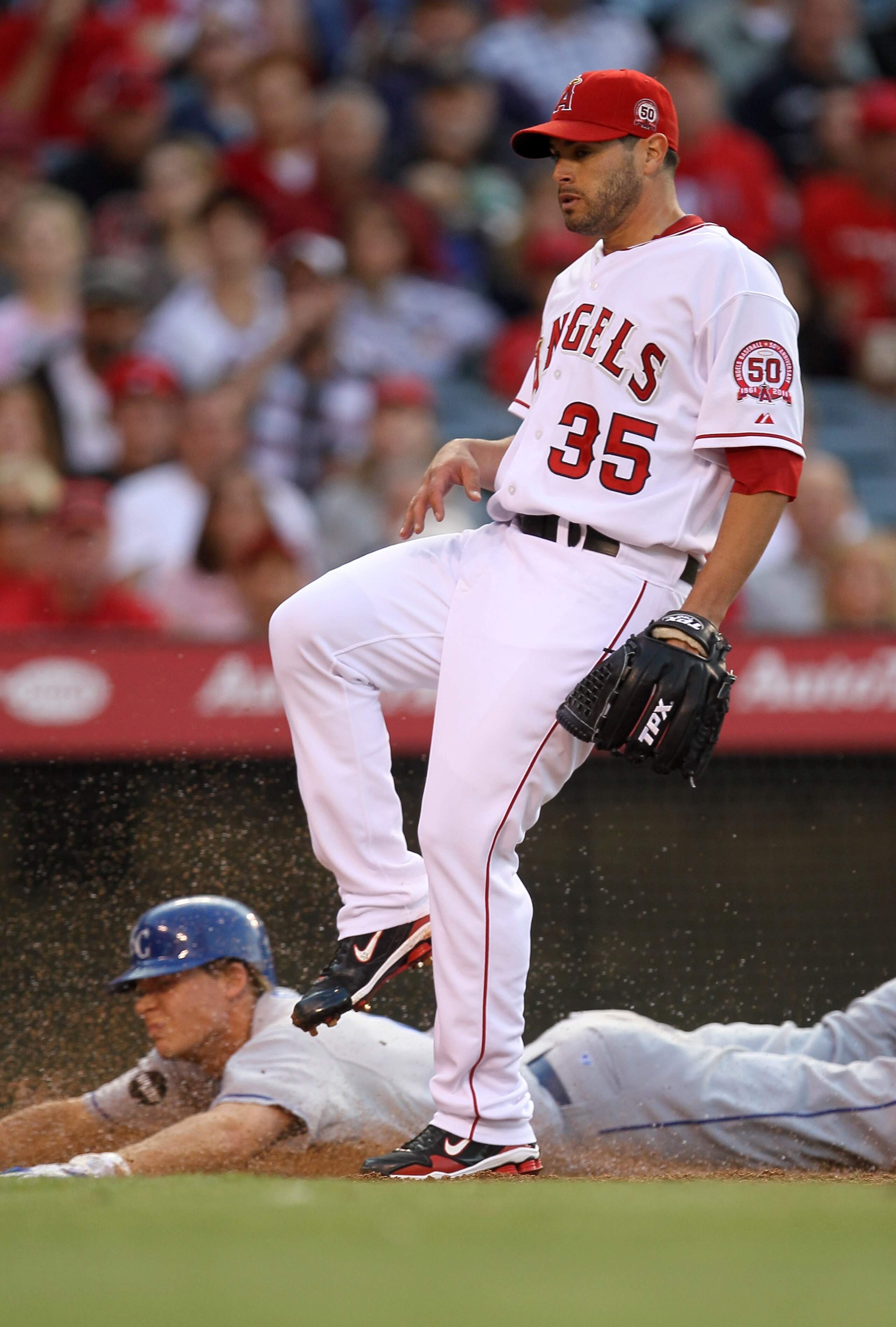 ANAHEIM, CA - JUNE 11: Pitcher Joel Pineiro #35 of the Los Angeles Angels of Anaheim covers home on his passed ball as Chris Getz #17 of the Kansas City Royals scores in the third inning on June 11, 2011 at Angel Stadium in Anaheim, California.  (Photo by