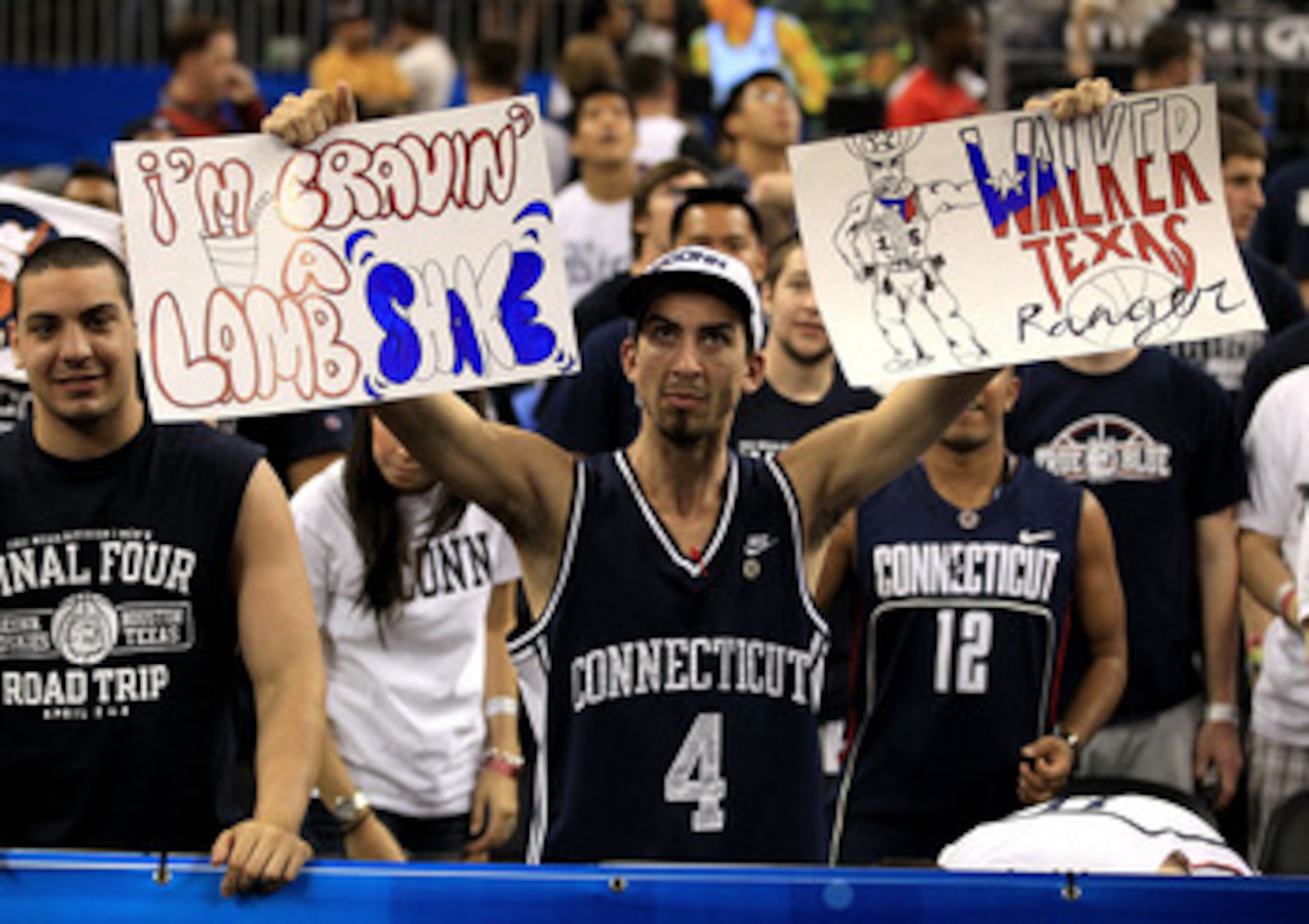 HOUSTON, TX - APRIL 04:  A Connecticut Huskies fan holds up signs before the Huskies take on the Butler Bulldogs in the National Championship Game of the 2011 NCAA Division I Men's Basketball Tournament at Reliant Stadium on April 4, 2011 in Houston, Texa