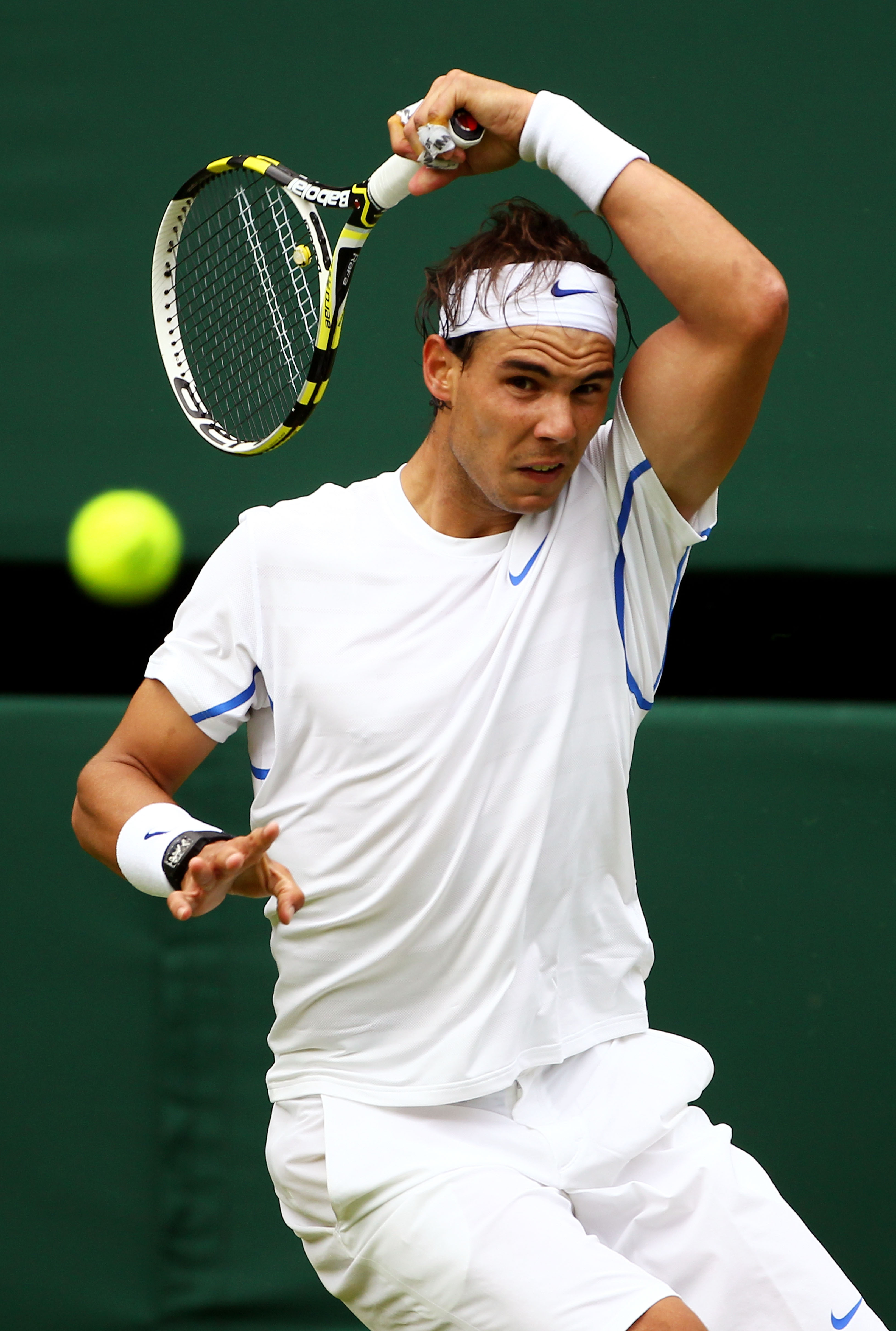 LONDON, ENGLAND - JUNE 20:  Rafael Nadal of Spain returns a shot during his first round match against Michael Russell of the United States on Day One of the Wimbledon Lawn Tennis Championships at the All England Lawn Tennis and Croquet Club on June 20, 20