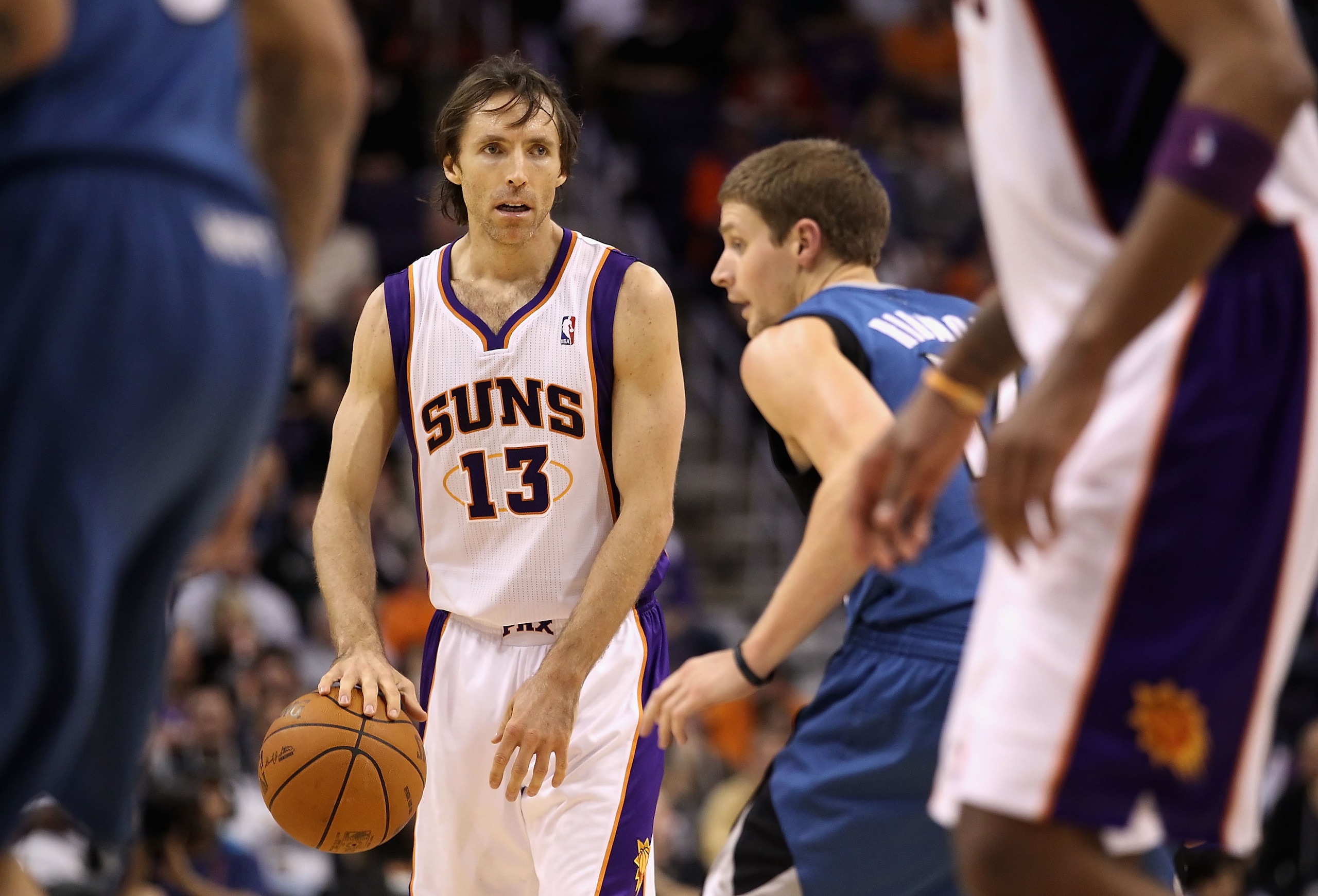PHOENIX - DECEMBER 15:  Steve Nash #13 of the Phoenix Suns handles the ball guared by Luke Ridnour #13 of the Minnesota Timberwolves during the NBA game at US Airways Center on December 15, 2010 in Phoenix, Arizona. The Suns defeated the Timberwolves 128-