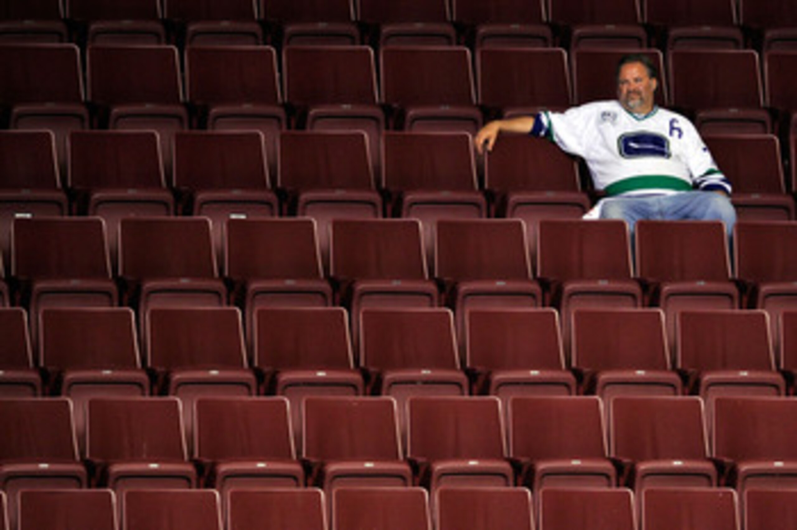 VANCOUVER, BC - JUNE 15:  A Vancouver Canucks fan sits in empty seats after the Vancouver Canucks were defeated by the Boston Bruins in Game Seven of the 2011 NHL Stanley Cup Final at Rogers Arena on June 15, 2011 in Vancouver, British Columbia, Canada. T