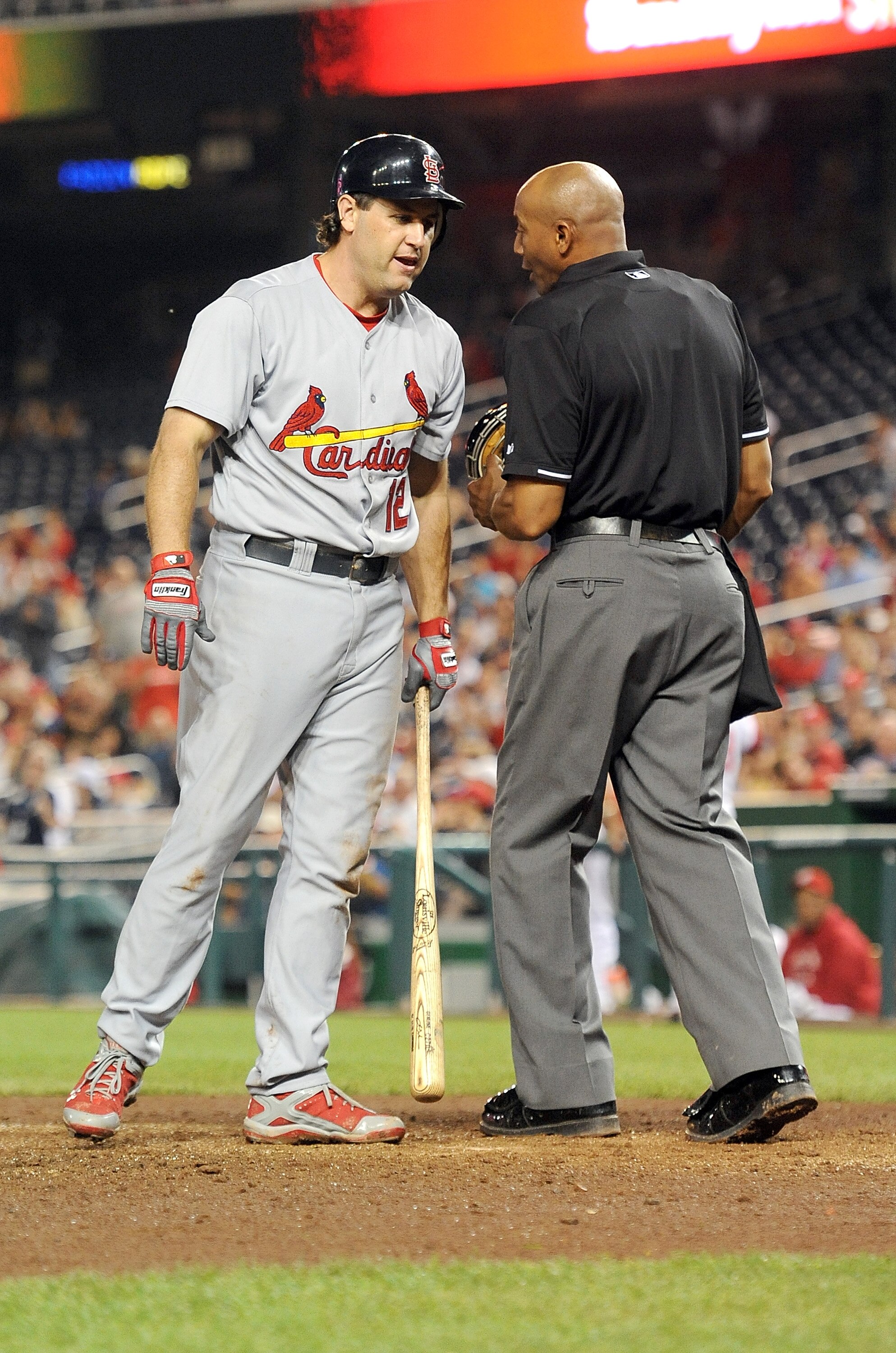WASHINGTON, DC - JUNE 16:  Lance Berkman #12 of the St. Louis Cardinals argues with home plate umpire CB Bucknor #54 after being called out on strikes to end the tenth inning against the Washington Nationals at Nationals Park on June 16, 2011 in Washingto