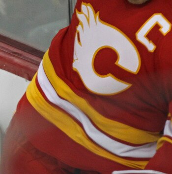 CALGARY, CANADA - APRIL 6: Jarome Iginla #12 of the Calgary Flames jousts with Ladislav Smid #5 of the Edmonton Oilers in first period NHL action on April 6, 2011 at the Scotiabank Saddledome in Calgary, Alberta, Canada. (Photo by Mike Ridewood/Getty Imag