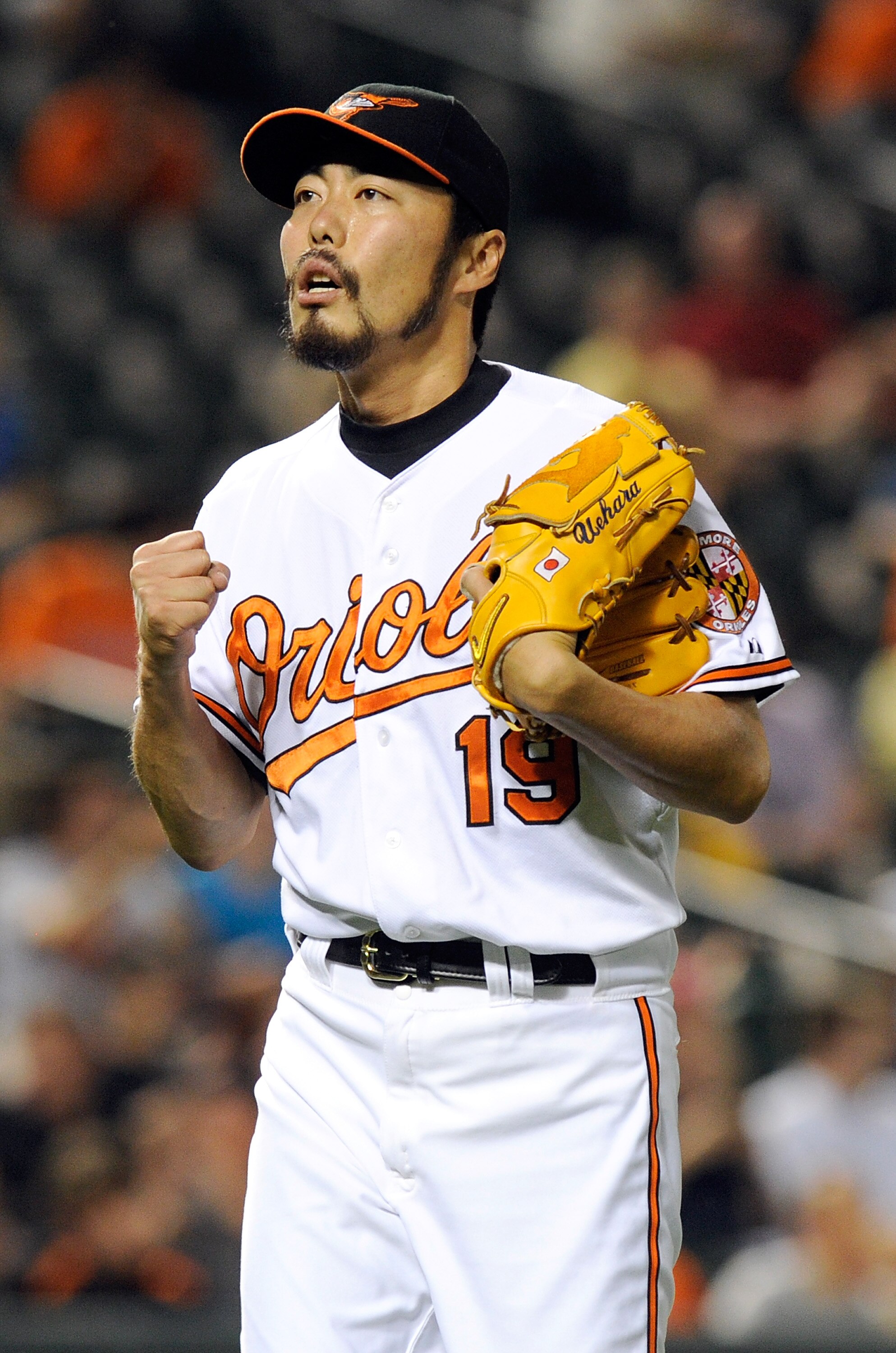 BALTIMORE, MD - JUNE 06:  Koji Uehara #19 of the Baltimore Orioles celebrates after the final out in the eighth inning against the Oakland Athletics at Oriole Park at Camden Yards on June 6, 2011 in Baltimore, Maryland. The Orioles won the game 4-2.  (Pho