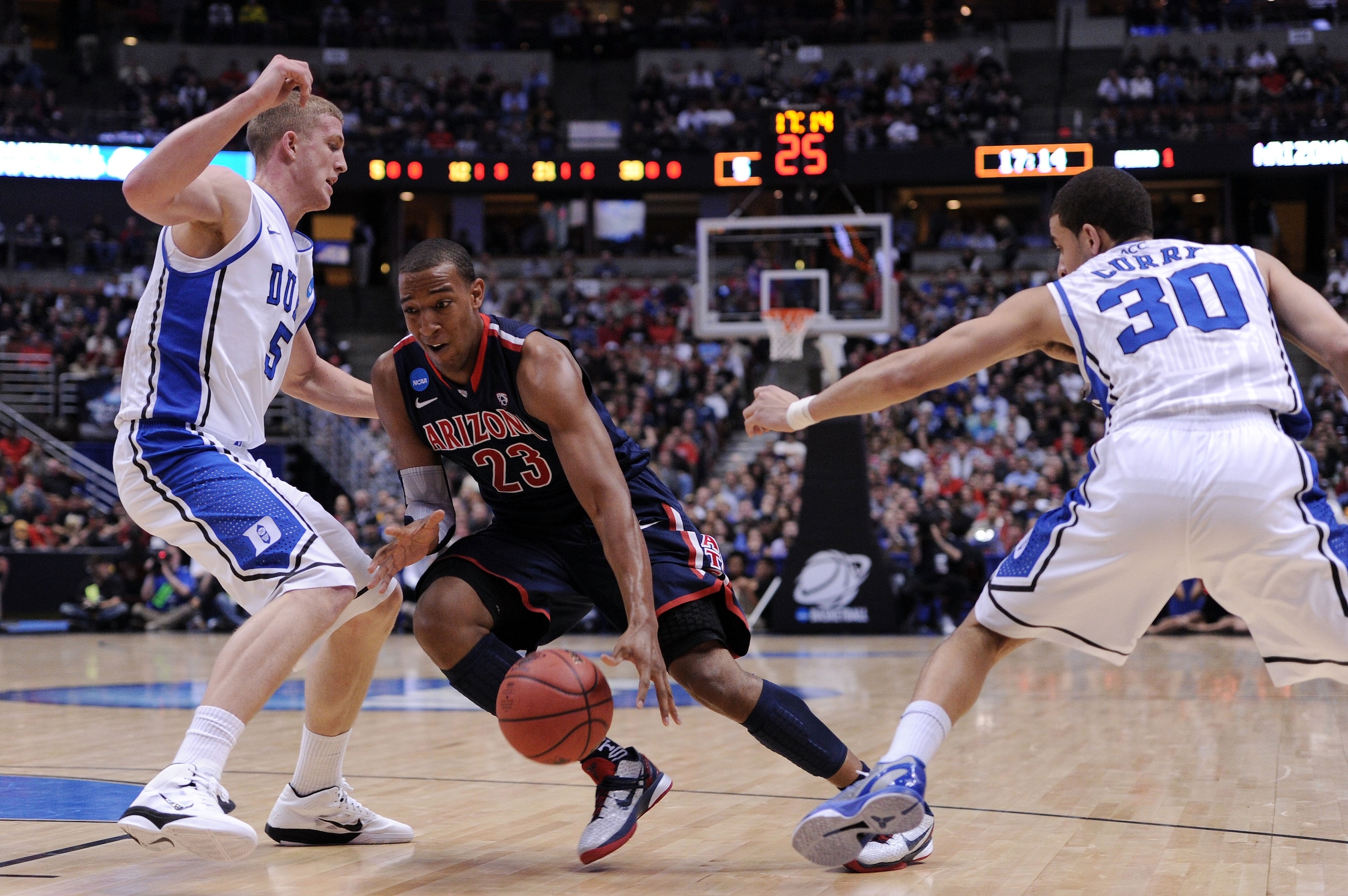 ANAHEIM, CA - MARCH 24:  Derrick Williams #23 of the Arizona Wildcats handles the ball against Mason Plumlee #5 and Seth Curry #30 of the Duke Blue Devils during the west regional semifinal of the 2011 NCAA men's basketball tournament at the Honda Center