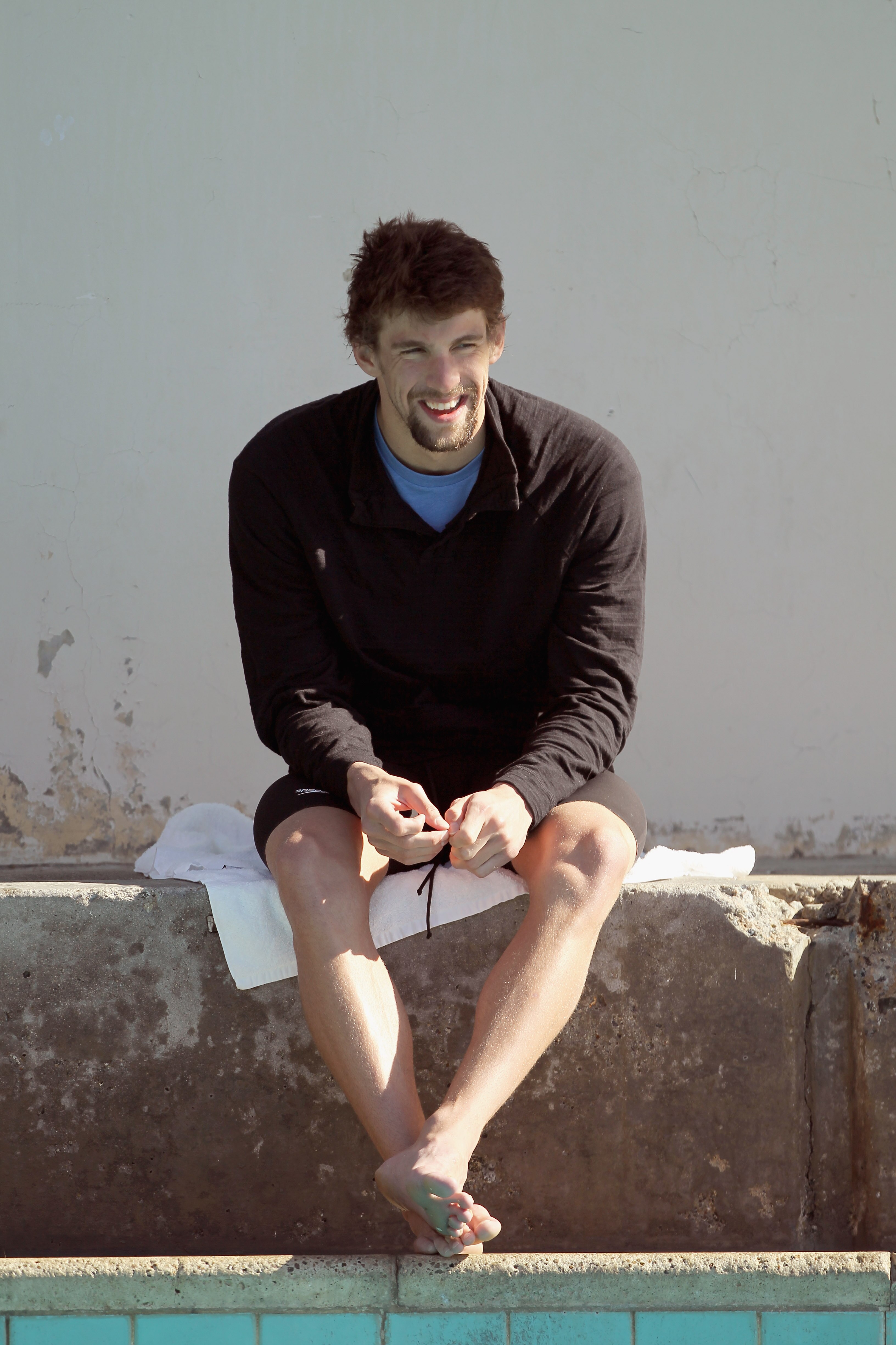 SANTA CLARA, CA - JUNE 19:  Michael Phelps sits by the side of the practice pool during day 4 of the Santa Clara International Grand Prix at George F. Haines International Swim Center on June 19, 2011 in Santa Clara, California.  (Photo by Ezra Shaw/Getty
