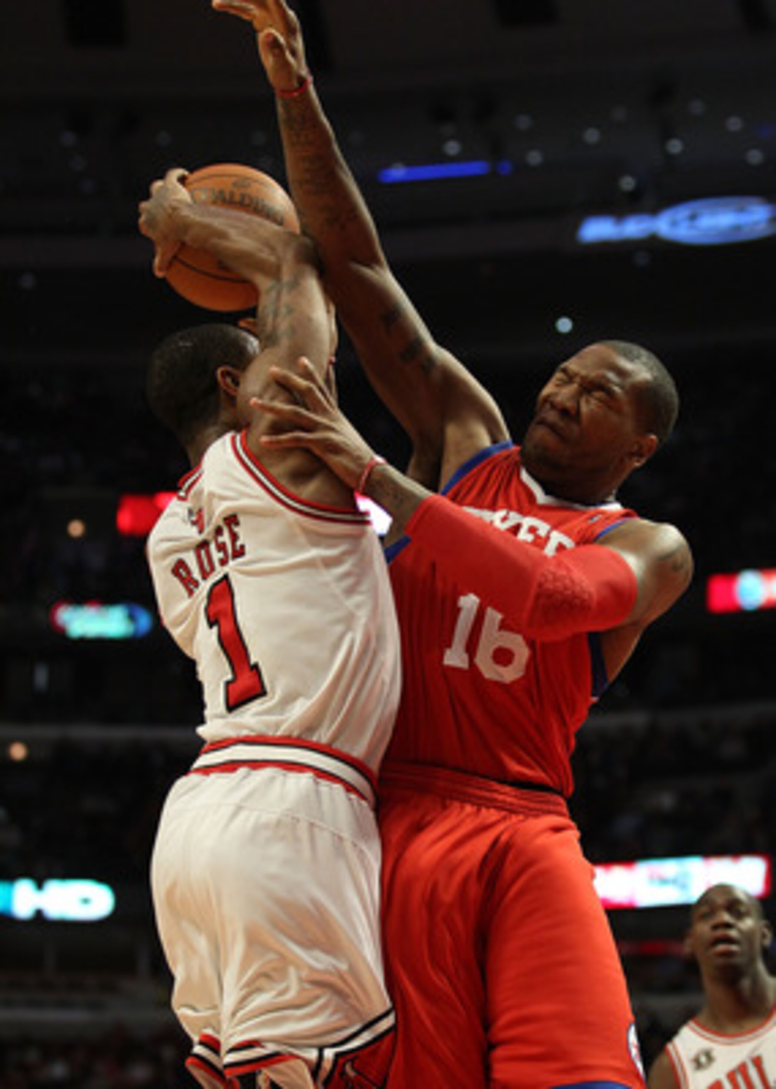 CHICAGO, IL - DECEMBER 21: Derrick Rose #1 of the Chicago Bulls is fouled while shooting by Marreese Speights #16 of the Philadelphia 76ers at the United Center on December 21, 2010 in Chicago, Illinois. The Bulls defeated the 76ers 121-76. NOTE TO USER: