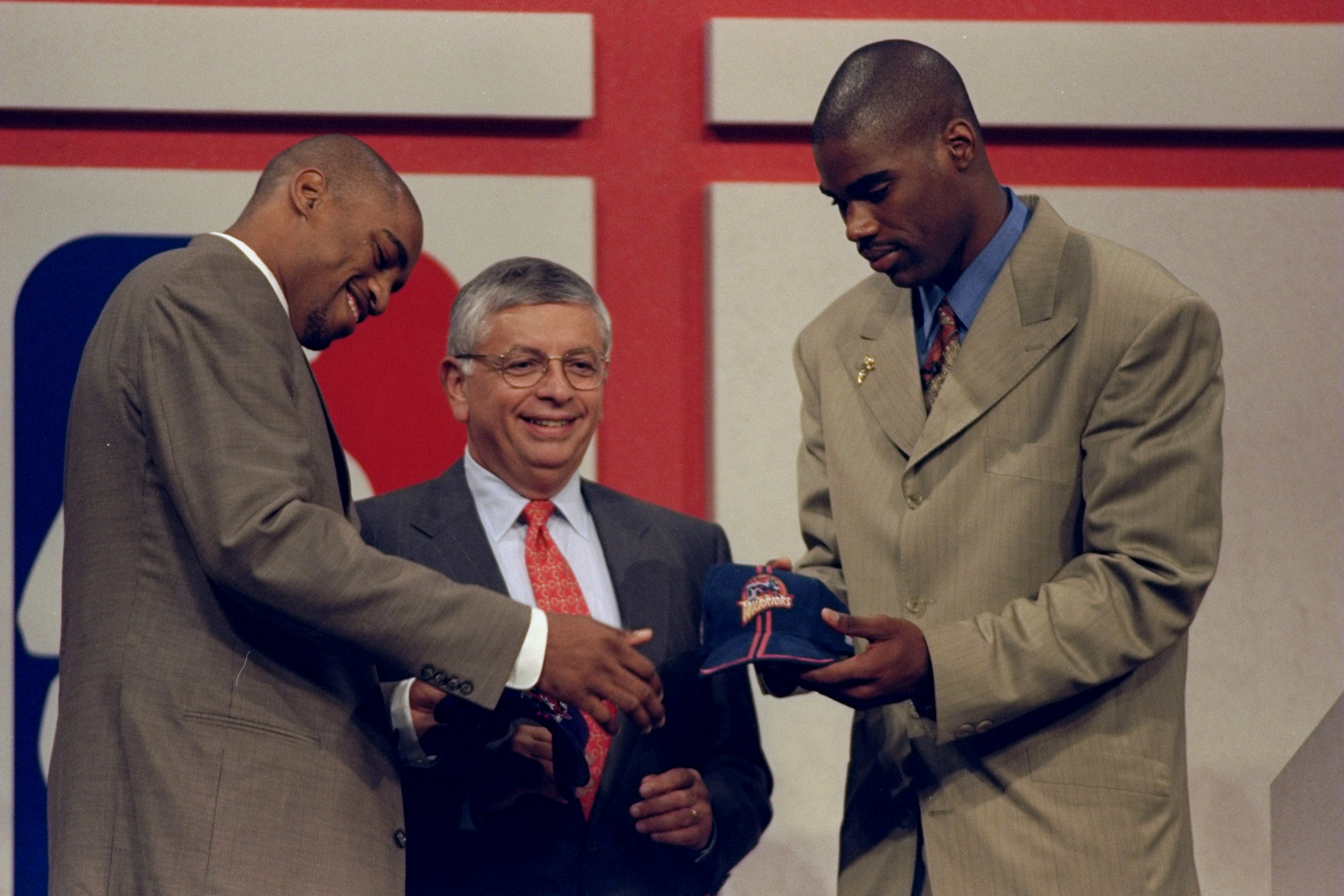 24 Jun 1998: A picture of Vince Carter (L) being traded to the Toronto Rapters and Antawn Jamison (R) being traded to the Golden State Warriors in front of David Stern the NBA Commissioner during the NBA Draft at the General Motors Palace in Vancouver, Ca