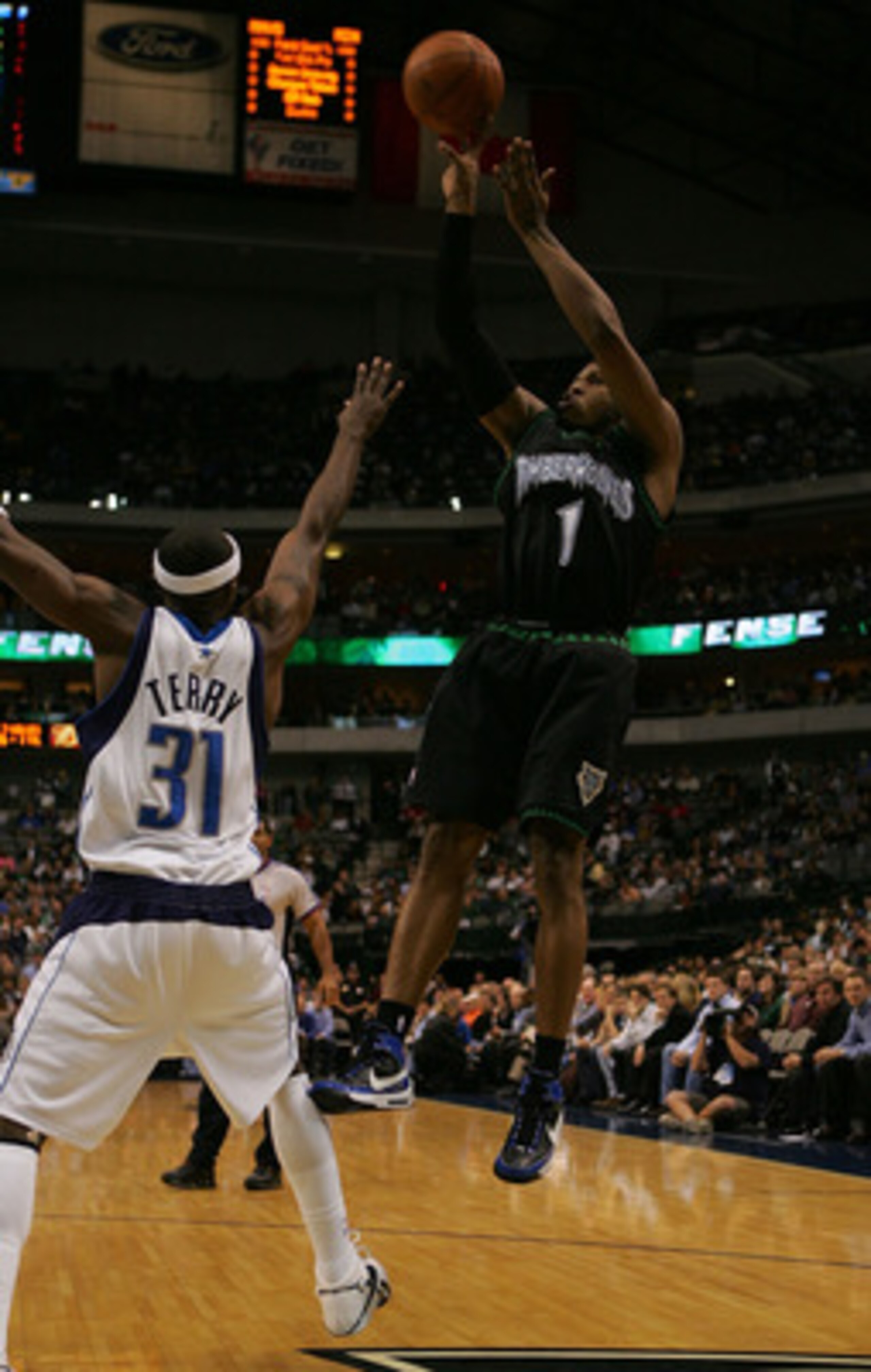 DALLAS - NOVEMBER 28: Guard Rashad McCants #1 of the Minnesota Timberwolves takes a shot against Jason Terry #31 of the Dallas Mavericks on November 28, 2007 at American Airlines Center in Dallas, Texas. NOTE TO USER: User expressly acknowledges and agr DALLAS - NOVEMBER 28: Guard Rashad McCants #1 of the Minnesota Timberwolves takes a shot against Jason Terry #31 of the Dallas Mavericks on November 28, 2007 at American Airlines Center in Dallas, Texas. NOTE TO USER: User expressly acknowledges and agr