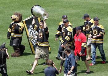 BOSTON, MA  - JUNE 19:  Zdeno Chara of the Boston Bruins hoists the Stanley Cup with his teammates before a game between the Boston Red Sox and the Milwaukee Brewers at Fenway Park on June 19, 2011 in Boston, Massachusetts.  (Photo by Jim Rogash/Getty Ima