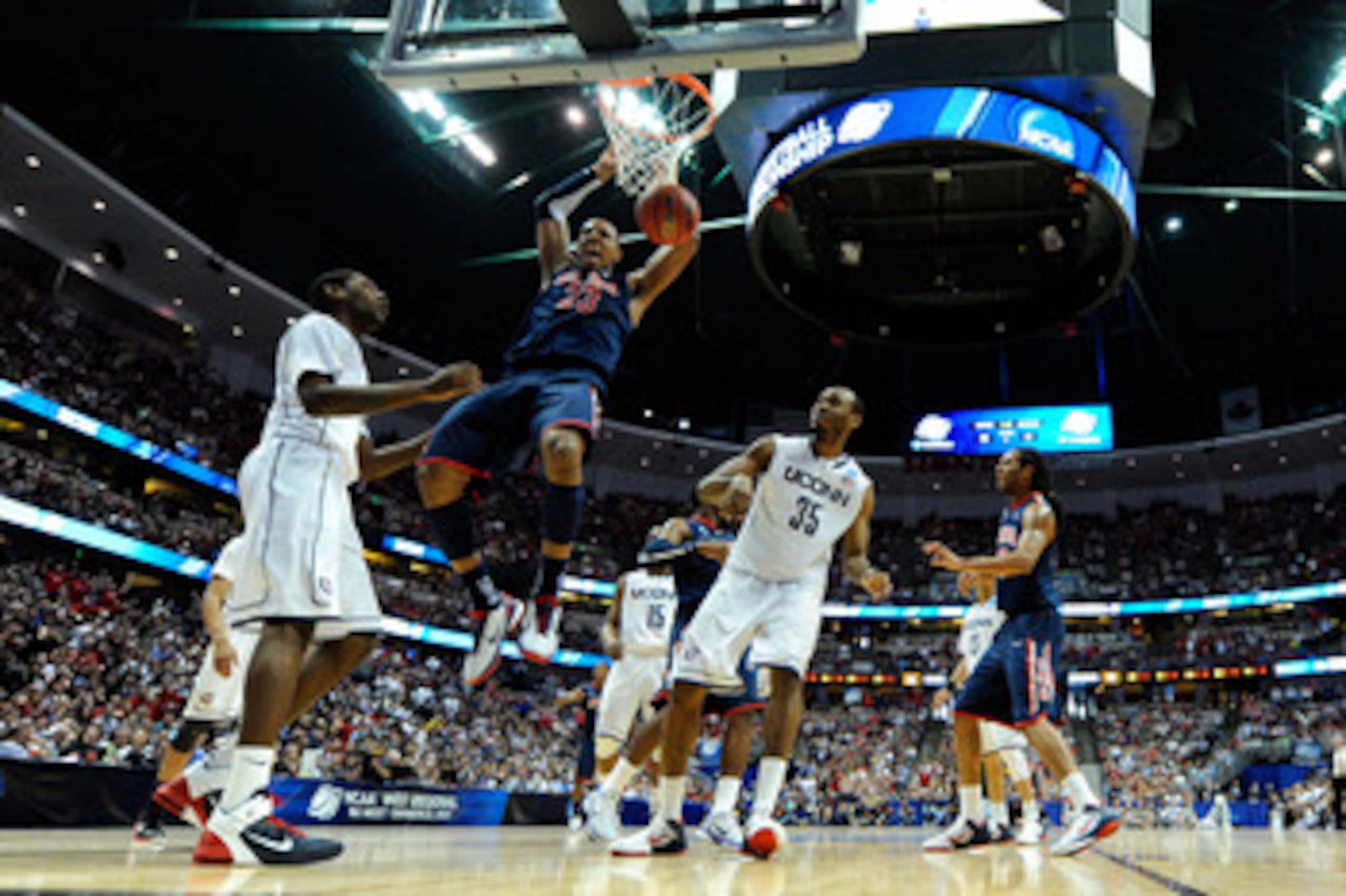 ANAHEIM, CA - MARCH 26:  Derrick Williams #23 of the Arizona Wildcats dunks the ball against Roscoe Smith #22 and Charles Okwandu #35 of the Connecticut Huskies during the west regional final of the 2011 NCAA men's basketball tournament at the Honda Cente