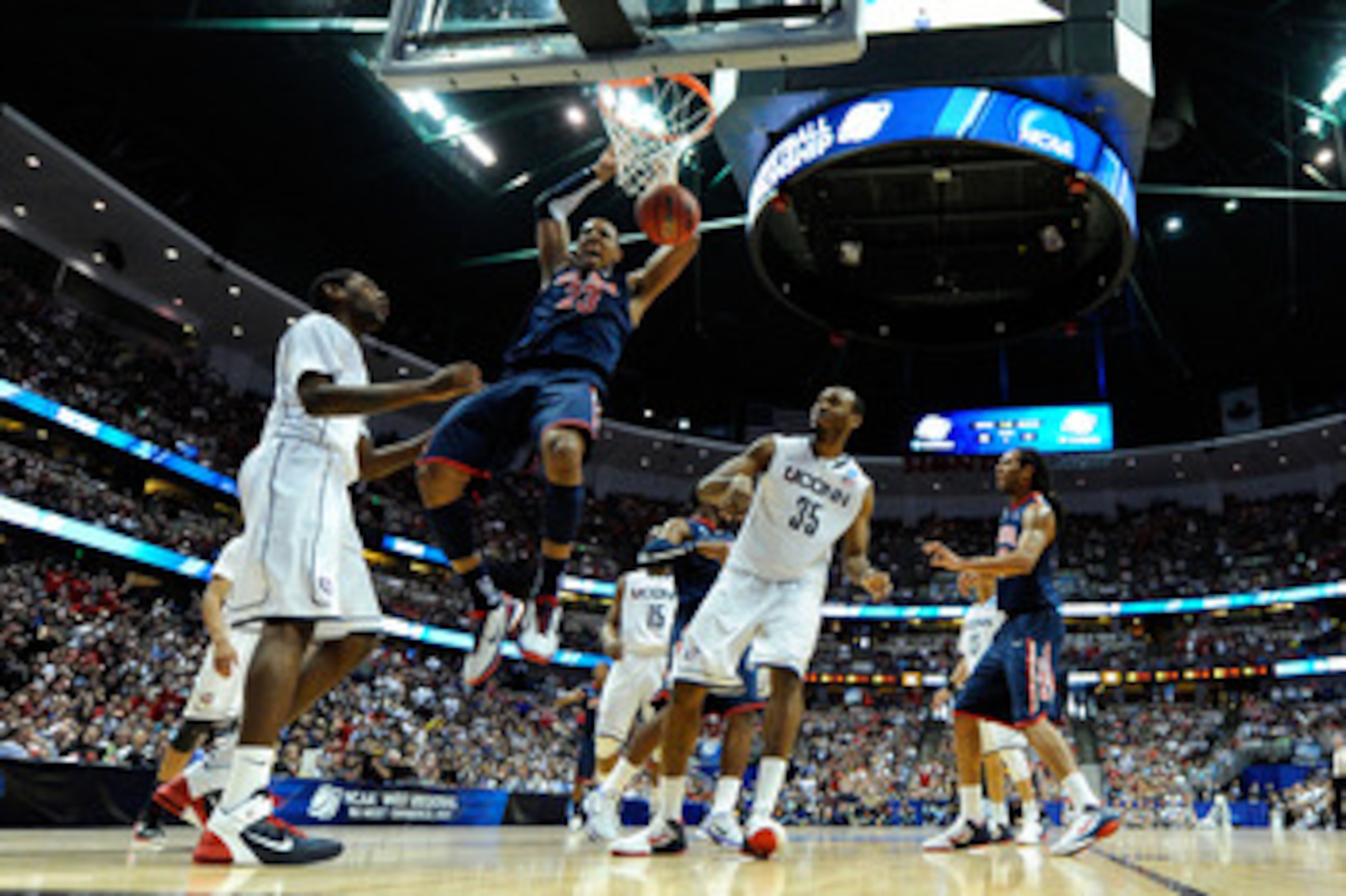 ANAHEIM, CA - MARCH 26: Derrick Williams #23 of the Arizona Wildcats dunks the ball against Roscoe Smith #22 and Charles Okwandu #35 of the Connecticut Huskies during the west regional final of the 2011 NCAA men's basketball tournament at the Honda Cente ANAHEIM, CA - MARCH 26: Derrick Williams #23 of the Arizona Wildcats dunks the ball against Roscoe Smith #22 and Charles Okwandu #35 of the Connecticut Huskies during the west regional final of the 2011 NCAA men's basketball tournament at the Honda Cente