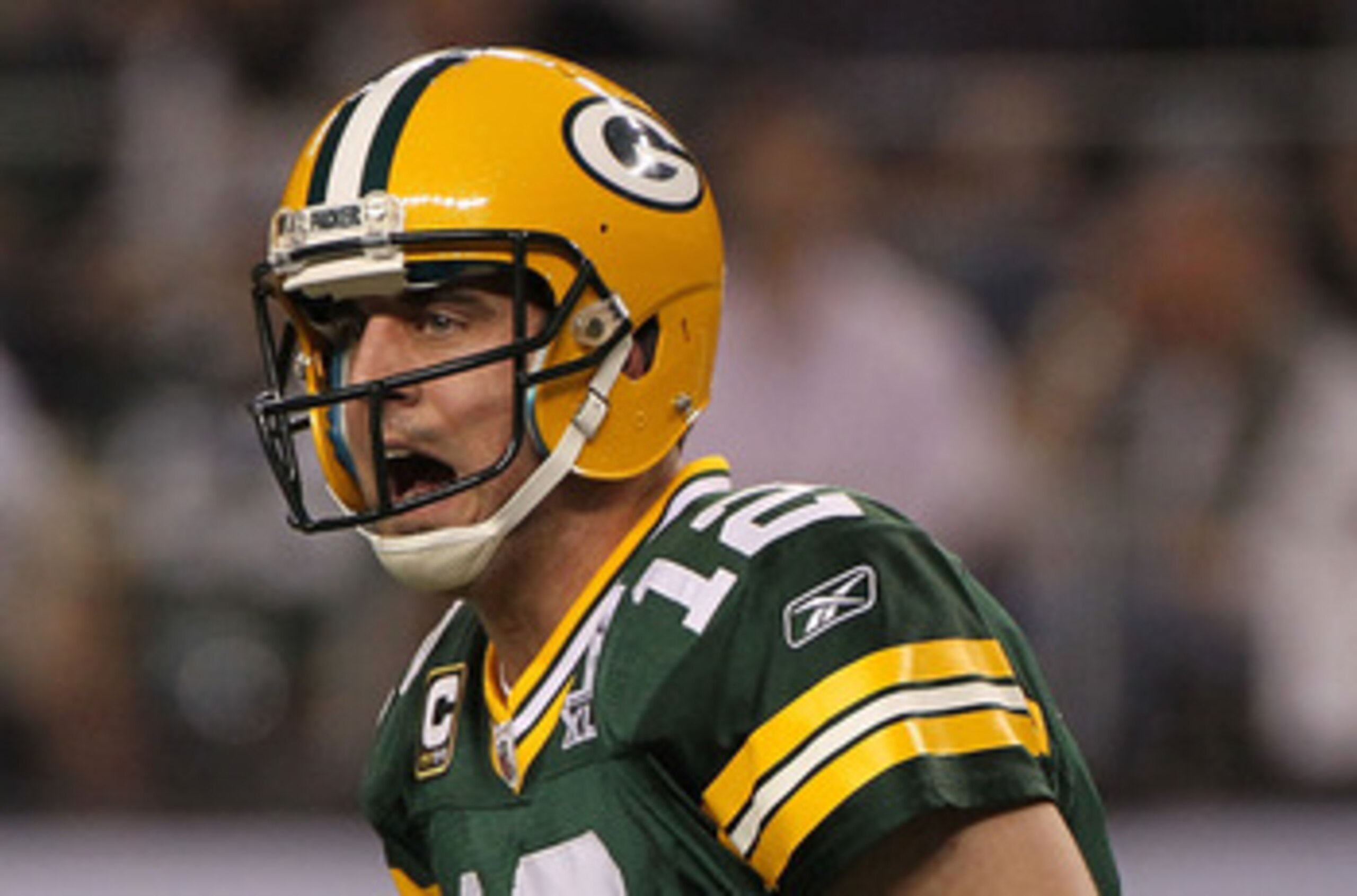 ARLINGTON, TX - FEBRUARY 06:  Quarterback Aaron Rodgers #12 of the Green Bay Packers calls out from under center while taking on the Pittsburgh Steelers during Super Bowl XLV at Cowboys Stadium on February 6, 2011 in Arlington, Texas.  (Photo by Doug Pens