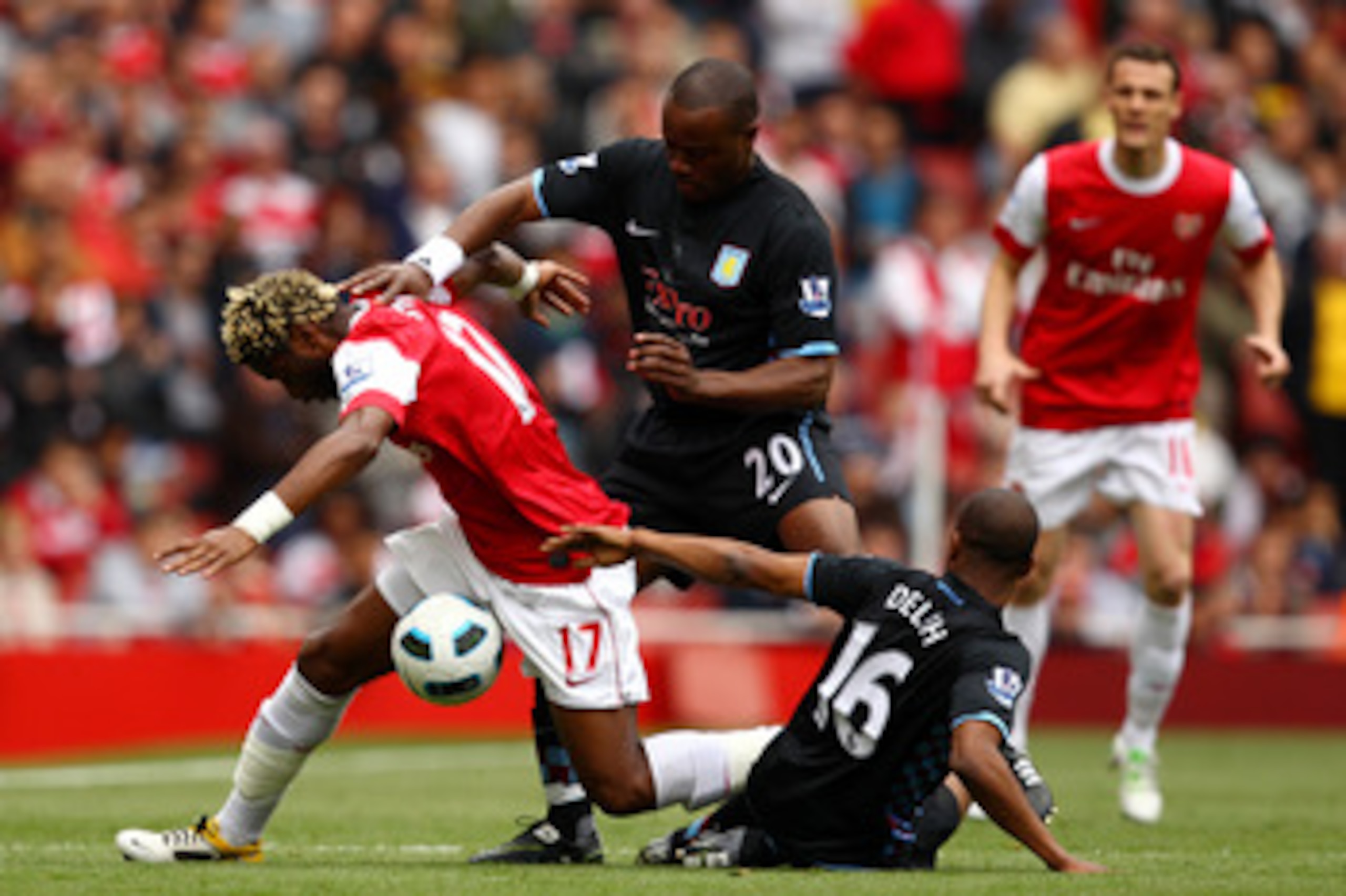 LONDON, ENGLAND - MAY 15:  Alex Song (L) of Arsenal in action against Nigel Reo-Coker (C) and Fabian Delph of Aston Villa during the Barclays Premier League match between Arsenal and Aston Villa at the Emirates Stadium on May 15, 2011 in London, England.