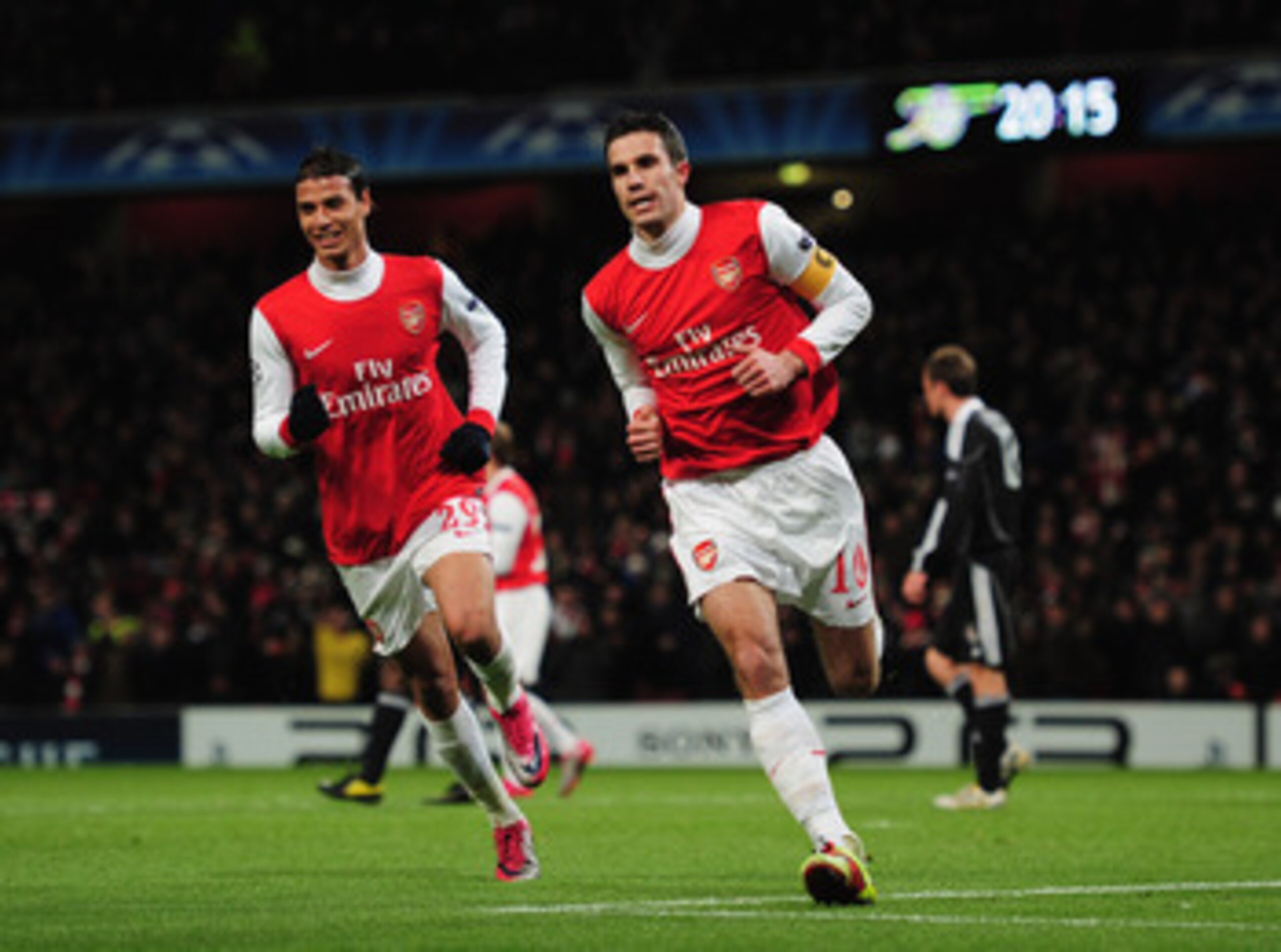 LONDON, ENGLAND - DECEMBER 08:  Robin van Persie of Arsenal celebrates with Marouane Chamakh (L) as he scores their first goal from the penalty spot during the UEFA Champions League Group H match between Arsenal and FK Partizan Belgrade at the Emirates St