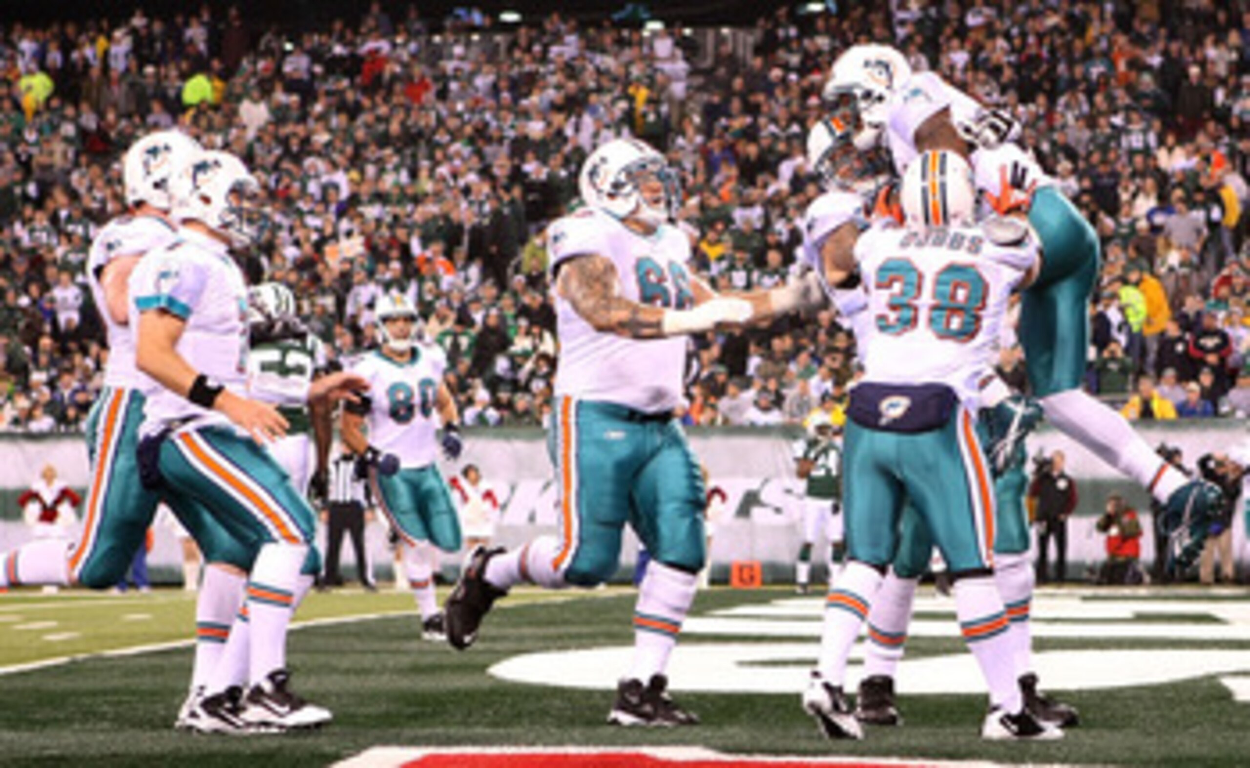 EAST RUTHERFORD, NJ - DECEMBER 12: The Miami Dolphins celebrate the touchdown of Brandon Marshall #19 against the New York Jets at New Meadowlands Stadium on December 12, 2010 in East Rutherford, New Jersey.  (Photo by Nick Laham/Getty Images)