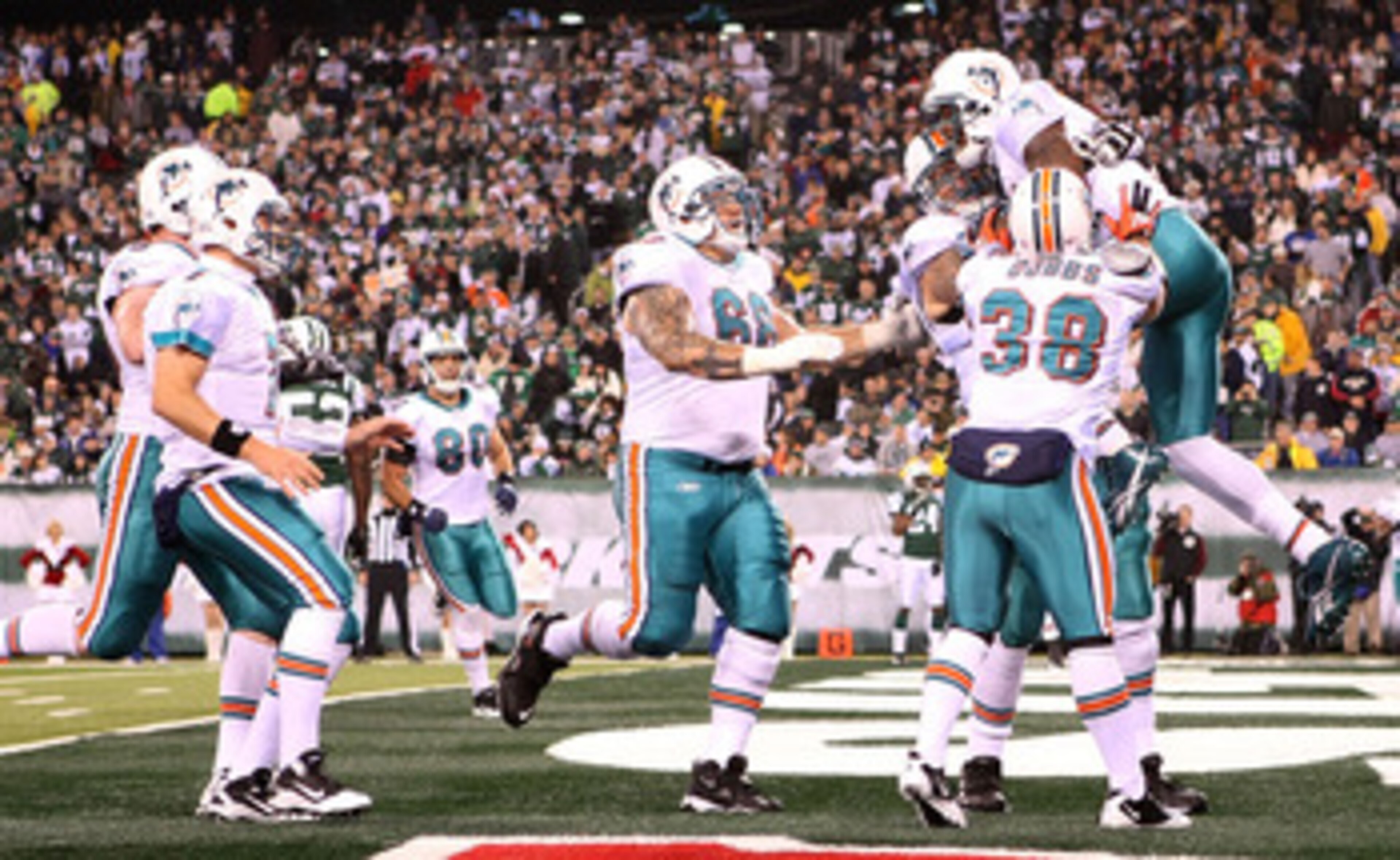 EAST RUTHERFORD, NJ - DECEMBER 12: The Miami Dolphins celebrate the touchdown of Brandon Marshall #19 against the New York Jets at New Meadowlands Stadium on December 12, 2010 in East Rutherford, New Jersey.  (Photo by Nick Laham/Getty Images)