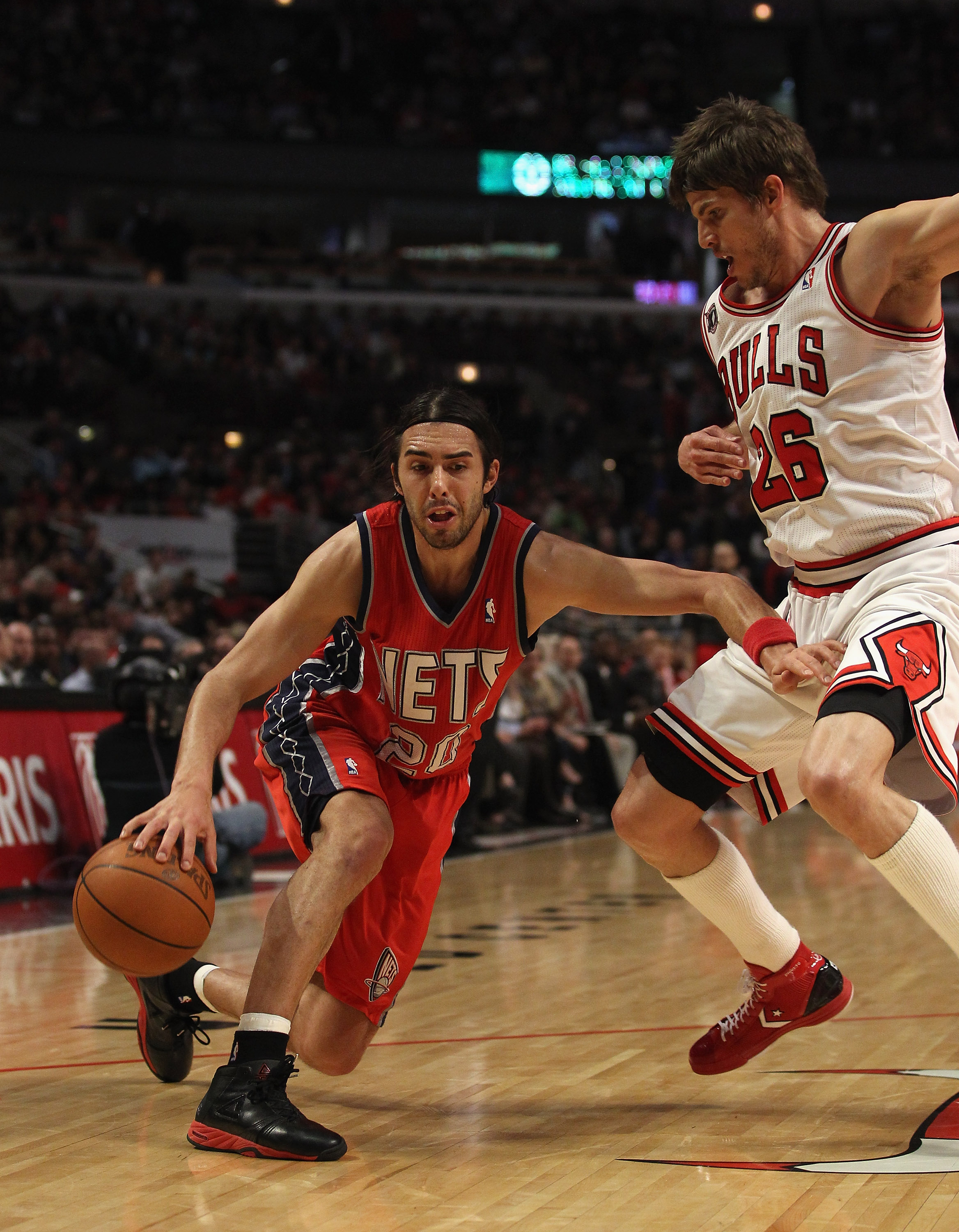 CHICAGO, IL - APRIL 13: Sasha Vujacic #20 of the New Jersey Nets moves against Kyle Korver #26 of the Chicago Bulls at the United Center on April 13, 2011 in Chicago, Illinois. The Bulls defeated the Nets 97-92. NOTE TO USER: User expressly acknowledges a CHICAGO, IL - APRIL 13: Sasha Vujacic #20 of the New Jersey Nets moves against Kyle Korver #26 of the Chicago Bulls at the United Center on April 13, 2011 in Chicago, Illinois. The Bulls defeated the Nets 97-92. NOTE TO USER: User expressly acknowledges a