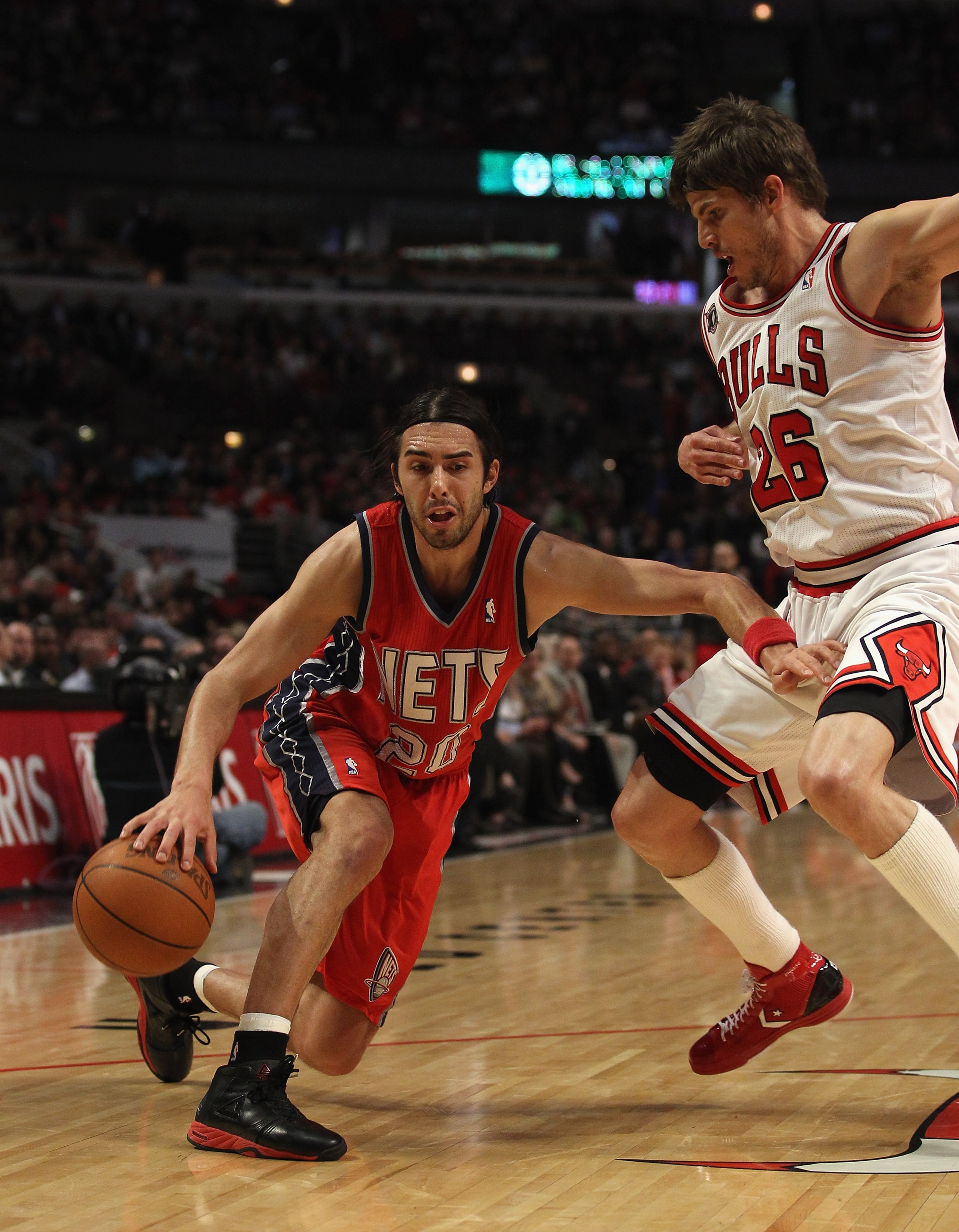 CHICAGO, IL - APRIL 13: Sasha Vujacic #20 of the New Jersey Nets moves against Kyle Korver #26 of the Chicago Bulls at the United Center on April 13, 2011 in Chicago, Illinois. The Bulls defeated the Nets 97-92. NOTE TO USER: User expressly acknowledges a